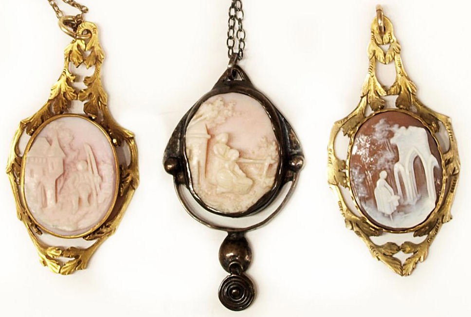 (3) ANTIQUE CARVED SCENIC CAMEO SHELL PENDANTS: (lot of 3) Antique carved cameo shell pendants, two having matching foliated frames set with intricately carved figural scenes, one depicting a castle hung from a chain, the one in a silver tone frame
