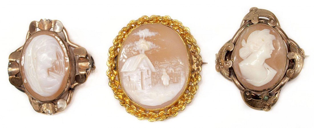 COLLECTION ANTIQUE CARVED CAMEO SHELL BROOCHES: (lot of 3) Carved cameo shell brooches, (2) showing the profile of a beauty, one lacking pin on back, the largest in a bright gold tone frame showing a house landscape with figure, overall: 1"h, 14 gr