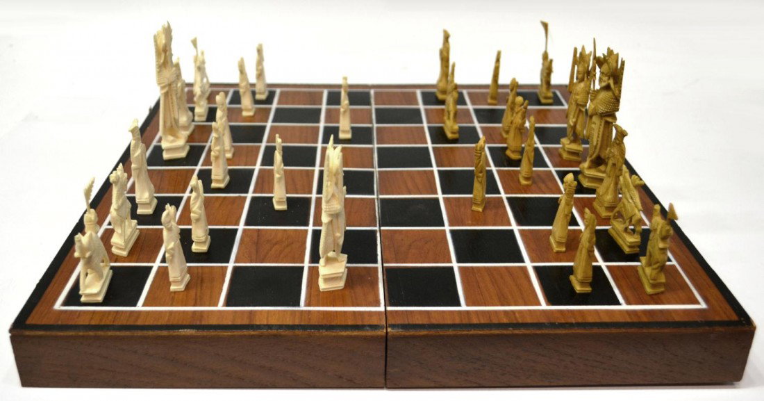CASED CHINESE CARVED FIGURAL IVORY CHESS SET: **This set will not be shipped Internationally** Chinese carved and stained ivory chess set in wood case, playing pieces with some loss/chipping overall, cased: 3"h, 16"l, 8"w, 4.5lbs total Start Pric