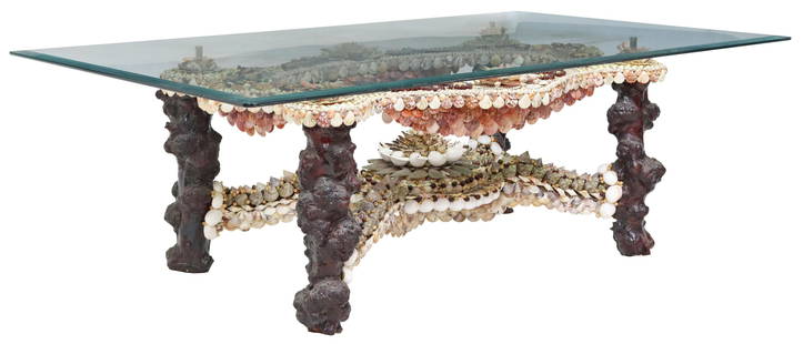 GLASS TOP SHELLWORK DECORATED TABLE: Shellwork decorated table, in the manner of Anthony Redmile (British, b.1940), late 20th c., beveled glass top, shell encrusted base accented with wood beads, approx 24.5"h, 72"w, 42"d Start Price: $2