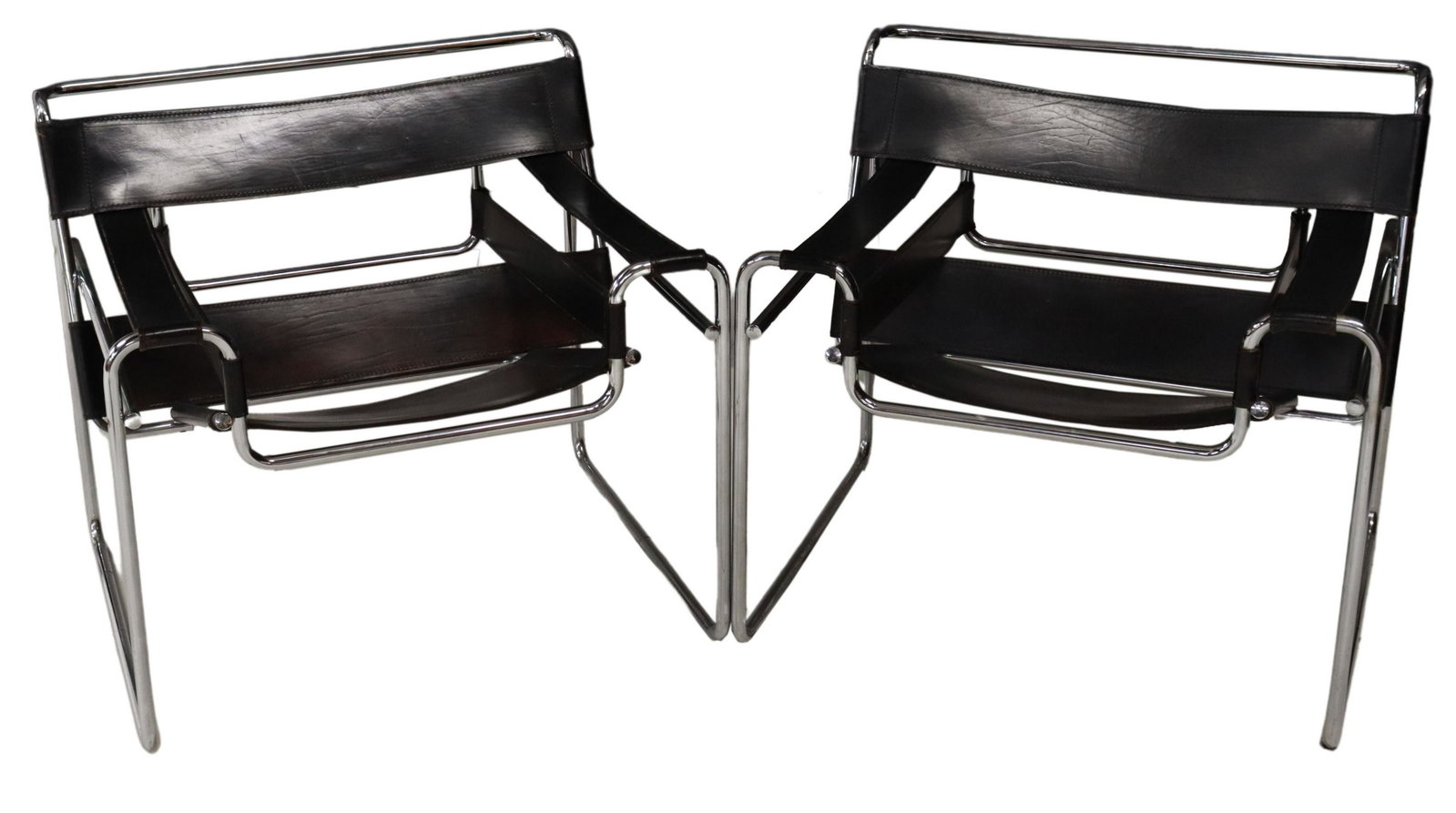 (2) MODERN WASSILY STYLE CHROME & LEATHER CHAIRS: (pair) Modernist "Wassily" style chairs, after Marcel Bruer (Hungarian, 1902-1981), chromed tubular steel frame, black leather back and seat, spotting/ uneven finish to leather, approx 28"h, 30.5"w, 2
