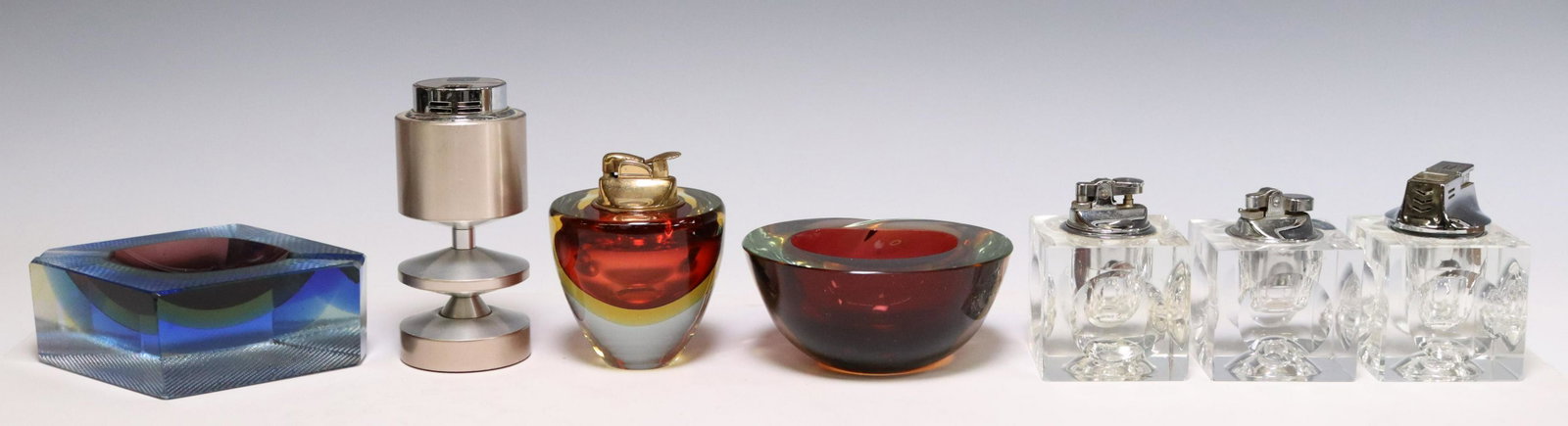 (7) MID-CENTURY TABLE LIGHTERS & MURANO ASHTRAYS: (lot of 7) Mid-century modern smoking-related items, including: (1) Sarome aluminum table lighter, (3) Nesor cut crystal cube table lighters, (1) Murano sommerso glass table lighter, (2) Murano art gl