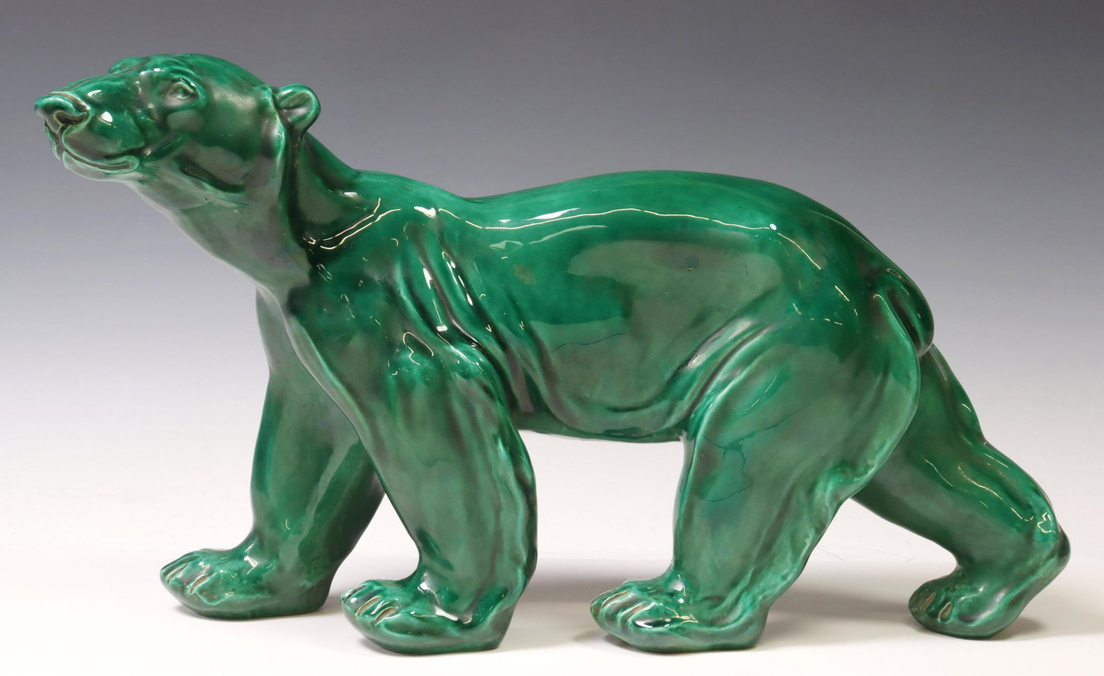 AFTER BONOME GLAZED CERAMIC SCULPTURE OF A BEAR: Ceramic sculpture of a polar bear, in a green glaze, after S.R. Bonome (Santiago Rodriguez Bonome, 1901-1995), approx 12.5"h, 21"l, 6.75lbs Start Price: $100.00