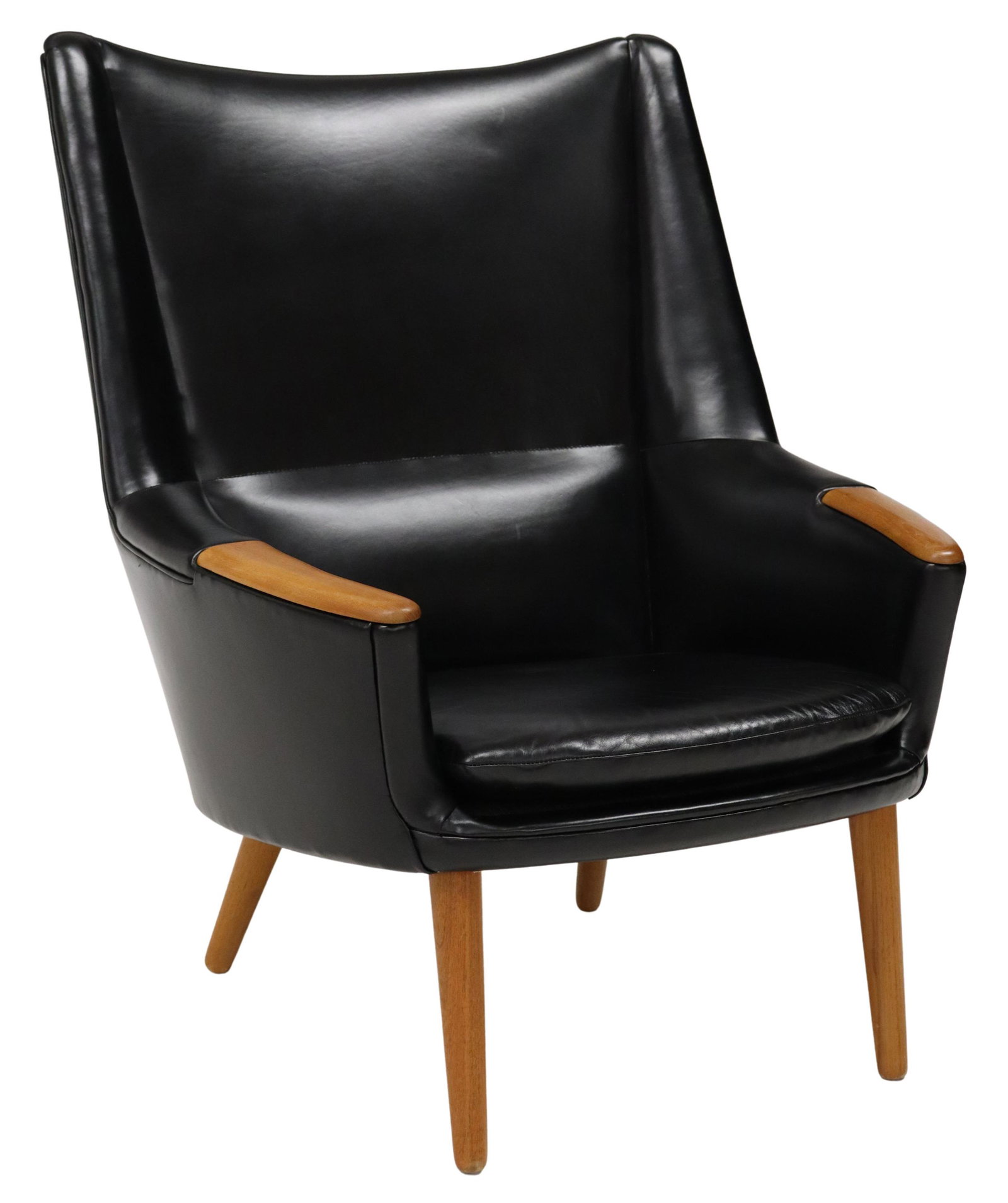 KURT OSTERVIG (1912-1986) MID-CENTURY LOUNGE CHAIR: Mid-century modern armchair, attributed to Kurt Ostervig (Danish, 1912-1986) for Rolschau Mobler, c.1950s, black leather upholstery, loose seat cushion, wood armrests, rising on tapered legs, no appar