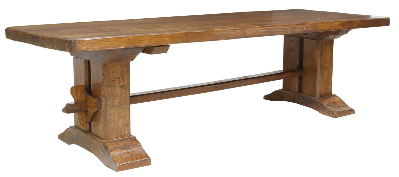 LARGE FRENCH OAK MONASTERY TABLE, 105.75"L: Large French oak monastery table, early 20th c., having plank top with rounded corners, rising on stretcher-joined trestle base, ending on bridge feet, approx 29.5"h, 105.75"l, 38"w Start Price: $800.