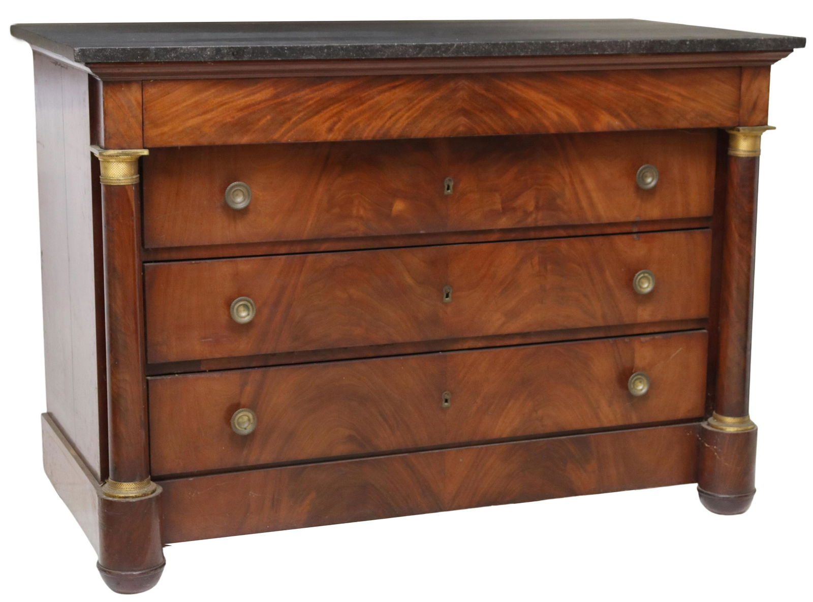 FRENCH EMPIRE STYLE MARBLE-TOP MAHOGANY COMMODE: French Empire style marble-top mahogany commode, 19th c., accented with gilt ormolu, having four drawers flanked by half columns, rising on tapered supports, approx 36"h, 51.75"w, 24.75"d Start Price: