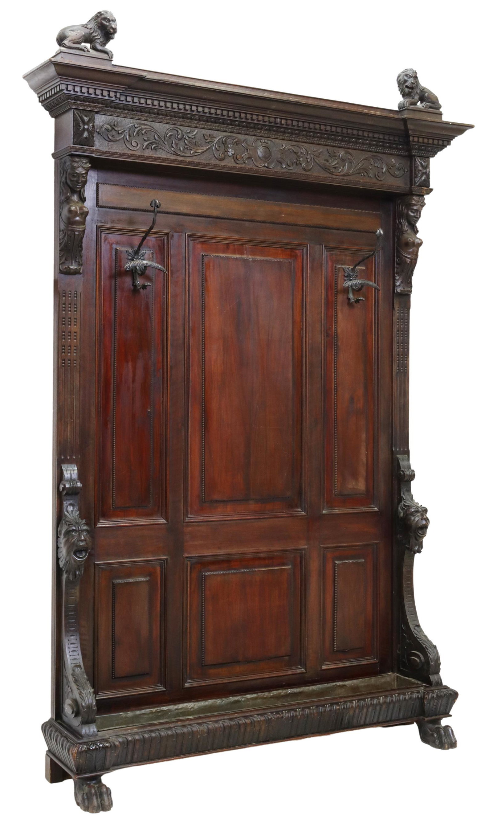 RENAISSANCE REVIVAL FIGURAL CARVED HALL TREE: Italian Renaissance Revival figural carved hall tree, 19th c., having carved lion finials, cornice over dentil trim, paneled back with female caryatid and grotesque supports, centering two coat hooks,