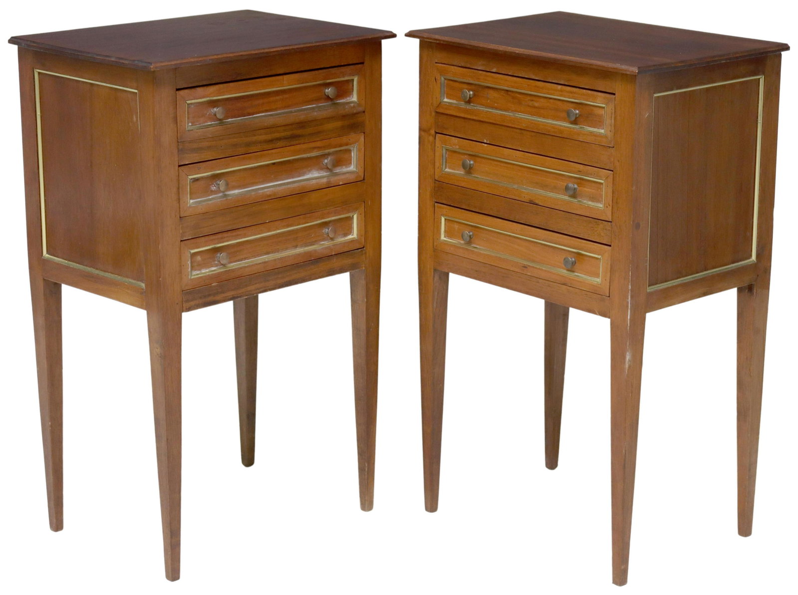 (2) FRENCH LOUIS XVI STYLE MAHOGANY NIGHTSTANDS: (pair) French Louis XVI style mahogany nightstands, 20th c., having three drawers, faced with gilt metal banding, rising on tapered legs, approx 29"h, 17.5"w, 12 5/8"d Start Price: $400.00
