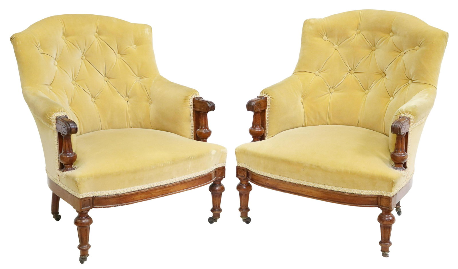 (2) FRENCH LOUIS XVI STYLE BUTTON-TUFTED BERGERES: (pair) French Louis XVI style armchairs, late 19th c., having shaped back, in a button-tufted upholstery, scrolled handholds, rising on fluted and tapered legs, ending on casters, (one) front caster l