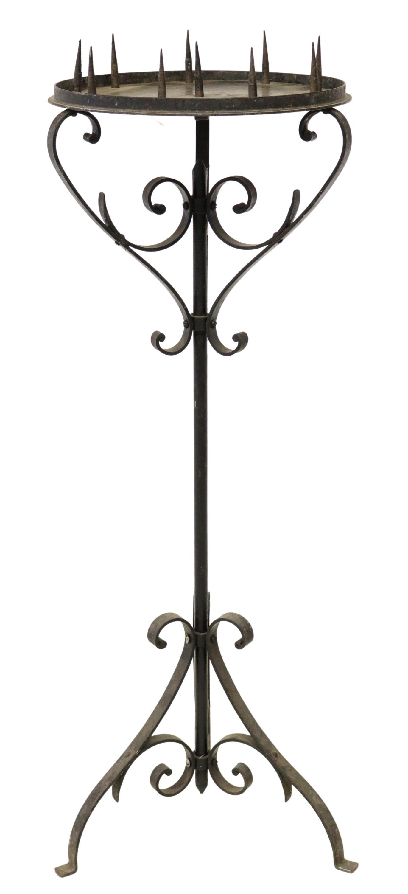 FRENCH WROUGHT IRON STANDING CANDLE PRICKET: French wrought iron standing candlestick, 20th c., having circular top with ten prickets, cylindrical standard, rising on scrolled tripartite base, approx 46"h, 16"diam Start Price: $100.00