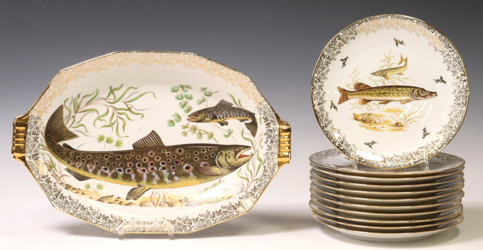 (12) FRENCH LIMOGES PORCELAIN FISH SERVICE: (lot of 12) French porcelain fish service, Ets. Chadelaud, mid to late 20th c., including: (11) individual plates, with (six) unique transfer printed designs, approx 8.25"diam, (1) serving platter, ap