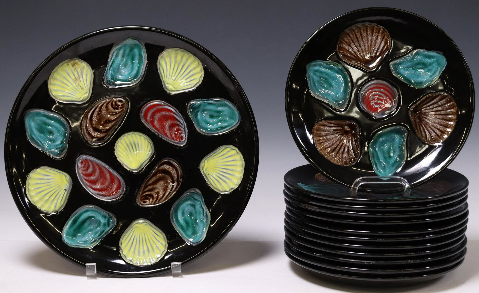 (13) FRENCH FAIENCE OYSTER PLATES & PLATTER: (lot of 13) French faience oyster service, Ceramiques Elchinger, mid 20th c., including: (12) individual plates, approx 10"diam, (1) serving platter, approx 13.5"diam; 19.25lbs total Start Price: $100