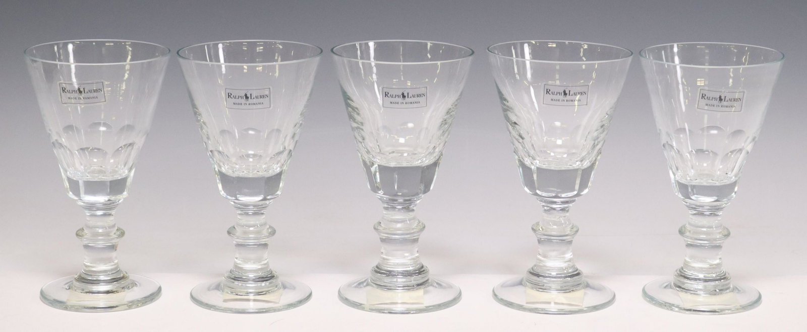 (5) RALPH LAUREN 'NEWSTEAD' CRYSTAL WINE GLASSES: (lot of 5) Crystal wine glasses, Ralph Lauren, in the "Newstead" pattern, panel cut on bowl, wafer stem, acid-etched mark at foot, approx 6.75"h, 3 7/8"diam; 4lbs total Start Price: $80.00