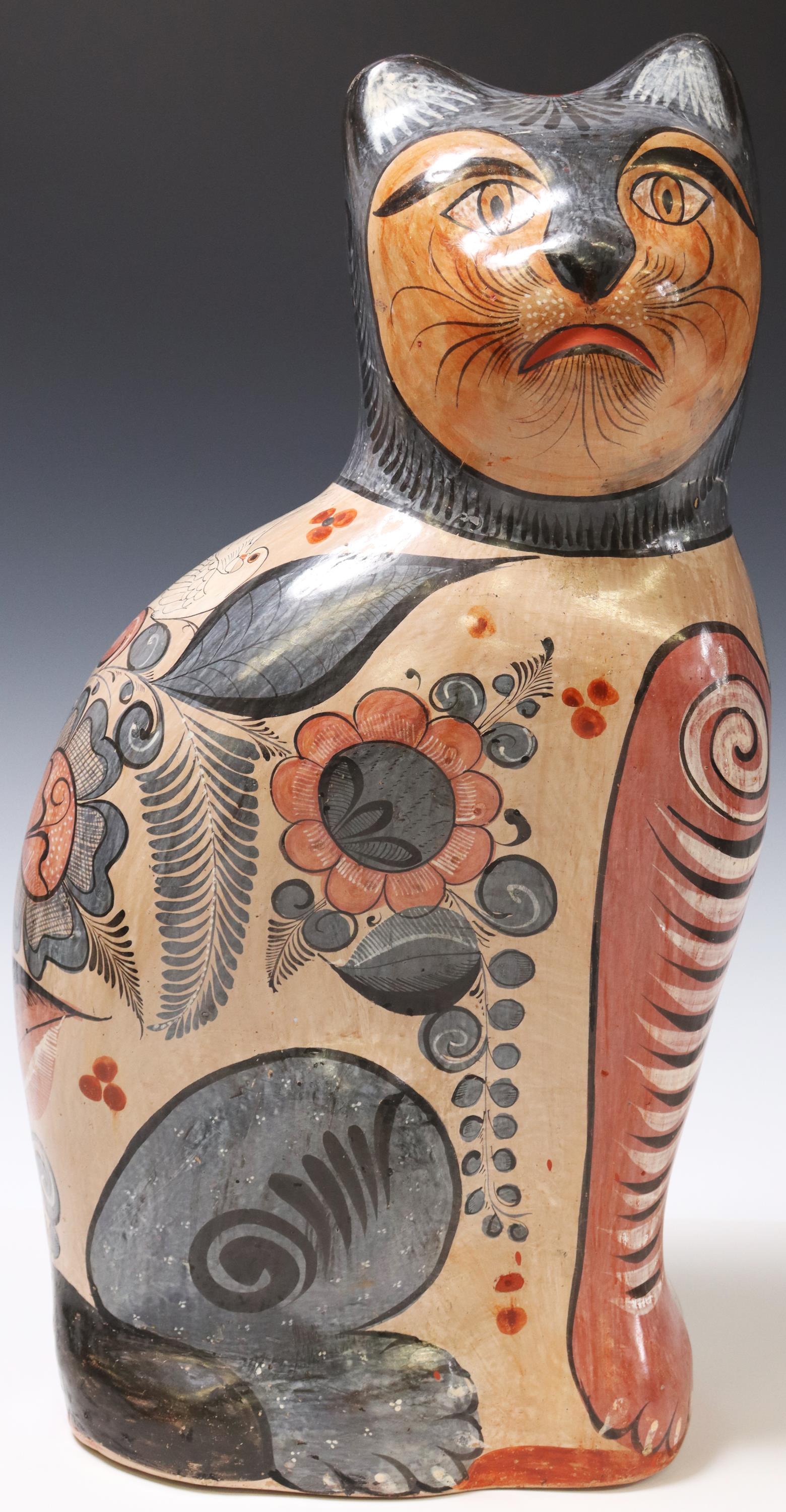 TONALA MEXICO FOLK ART POTTERY SEATED CAT: Tonala folk art pottery, Mexico, 20th c., depicting seated cat, decorated foliates in slip glazes, burnished finish, approx 21.75"h, 11"w, 7.75"d, 10.5lbs Start Price: $100.00