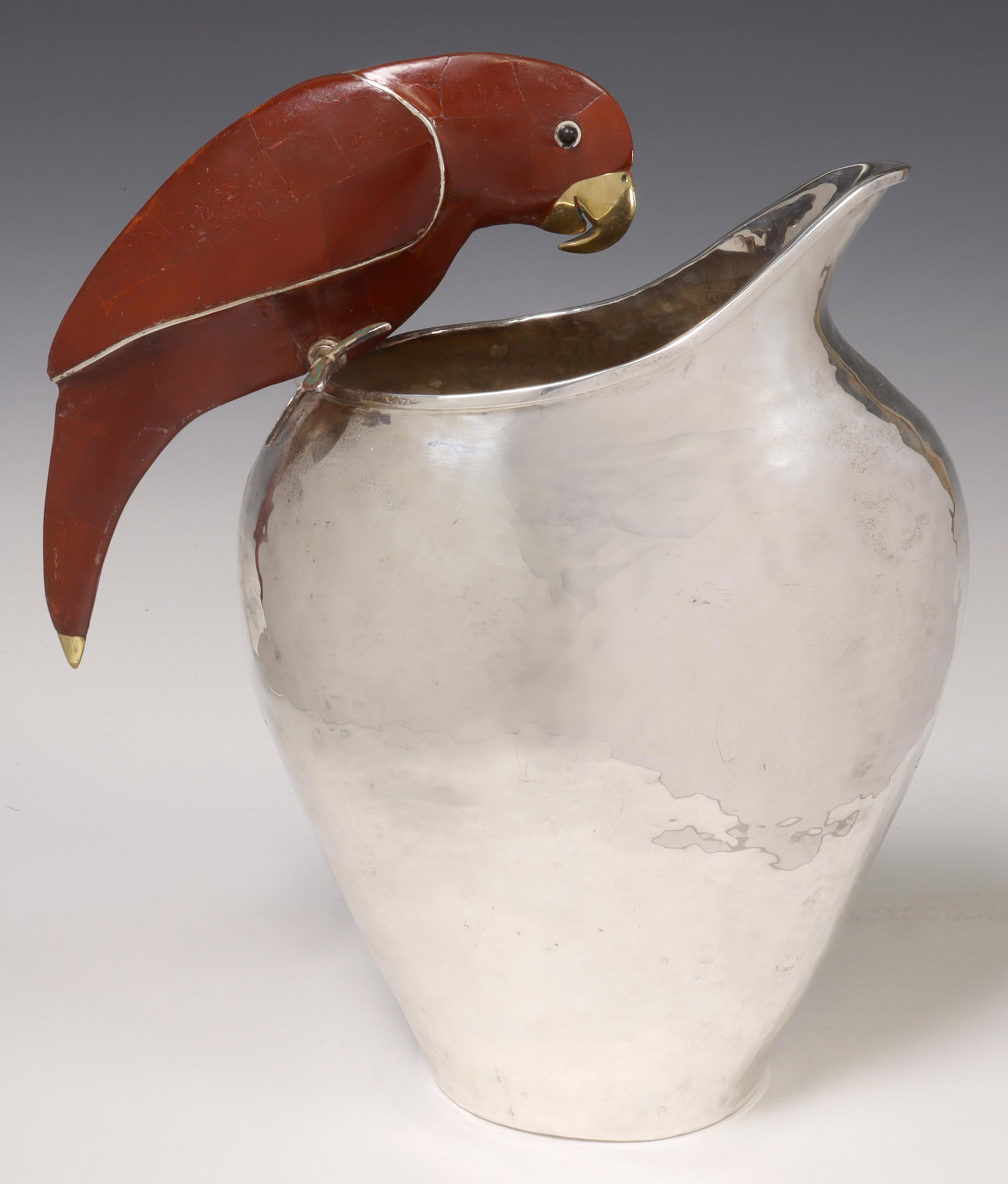 EMILIA CASTILLO INLAID PARROT SILVERPLATE PITCHER: Vintage hammered silverplate pitcher, Emilia Castillo, Taxco, Mexico, parrot-form handle with tiled red stone and turquoise inlay, marked underfoot, originally retailed by Neiman Marcus, approx 12.25"