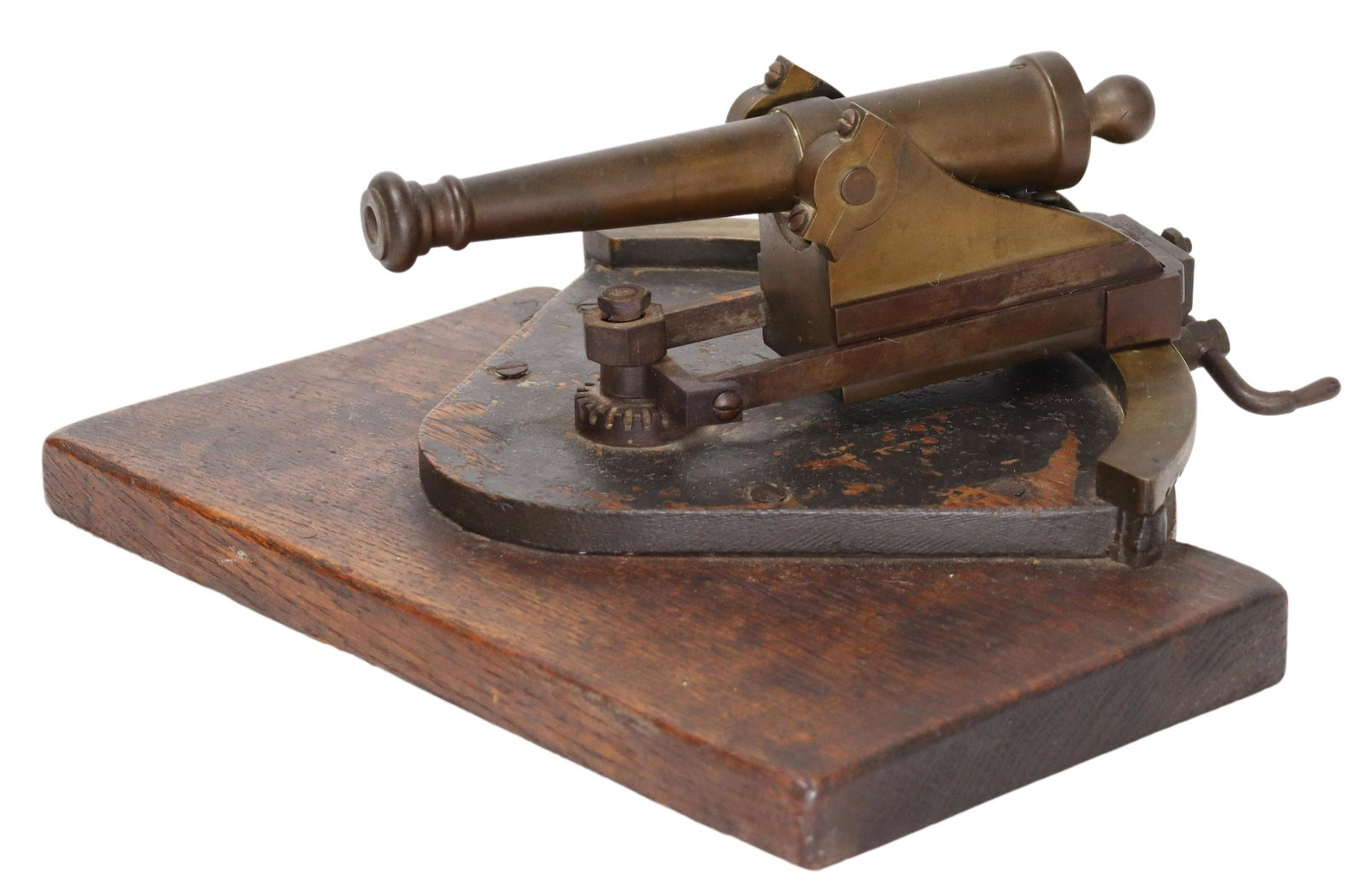 PATINATED BRONZE SIGNAL CANNON ON SWIVEL BASE: Patinated bronze fortification/ signal cannon, on crank-operated gear tooth pivot base, further raised on integral wood platform, apparently unmarked, approx 5"h, 11.75"w, 12"d, 7.1lbs Start Price: $8