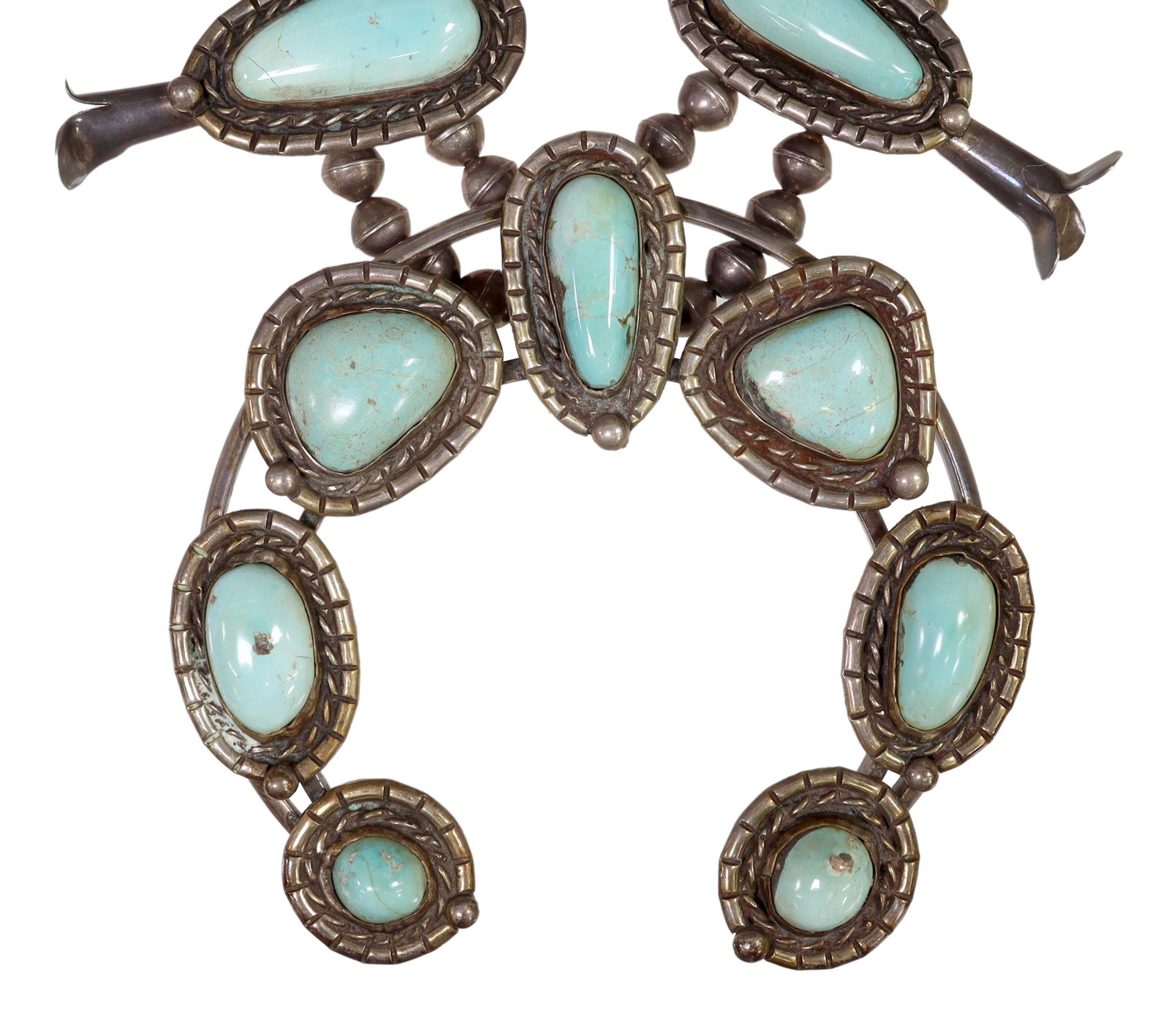 NATIVE AMERICAN TURQUOISE SQUASH BLOSSOM NECKLACE: Native American silver (content unknown) squash blossom necklace, having eight blossoms, central naja pendant, all set with turquoise cabochons, double bench bead strands, ending in a single strand, w