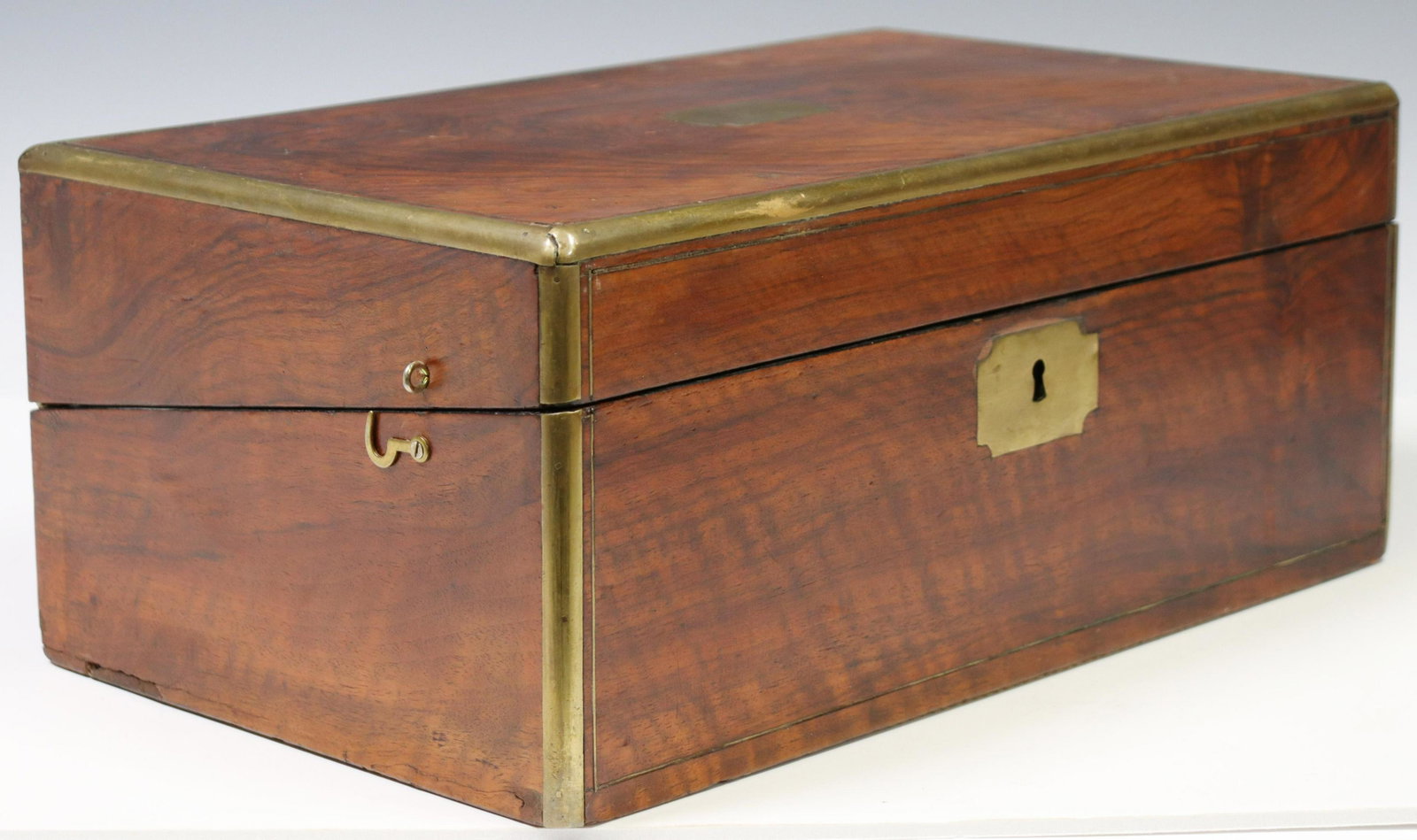 ENGLISH BRASS-MOUNTED WALNUT WRITING SLOPE BOX: English brass-mounted walnut writing slope/ travel desk, 19th c., hinged lid opening to inset velvet writing surface, pen rest and inkwell compartments, later side latches, approx 6.5"h, 15.75"w, 9.5"