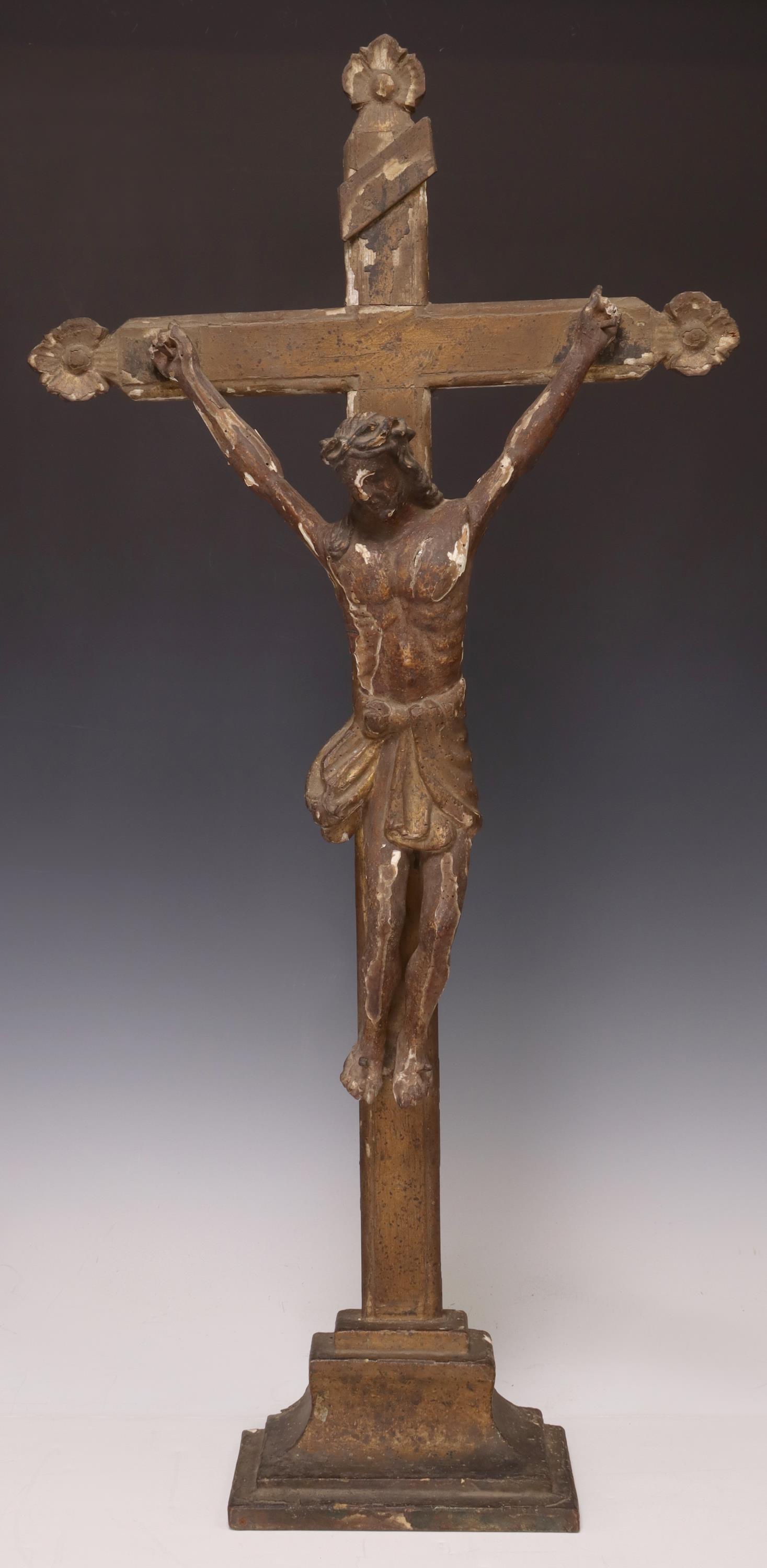 CONTINENTAL CARVED WOOD TABLETOP ALTAR CRUCIFIX: Continental carved wood altar crucifix, on an integral base, typical losses, approx 29.25"h, 14.5"w, 4.25"d, 2.75lbs Start Price: $100.00