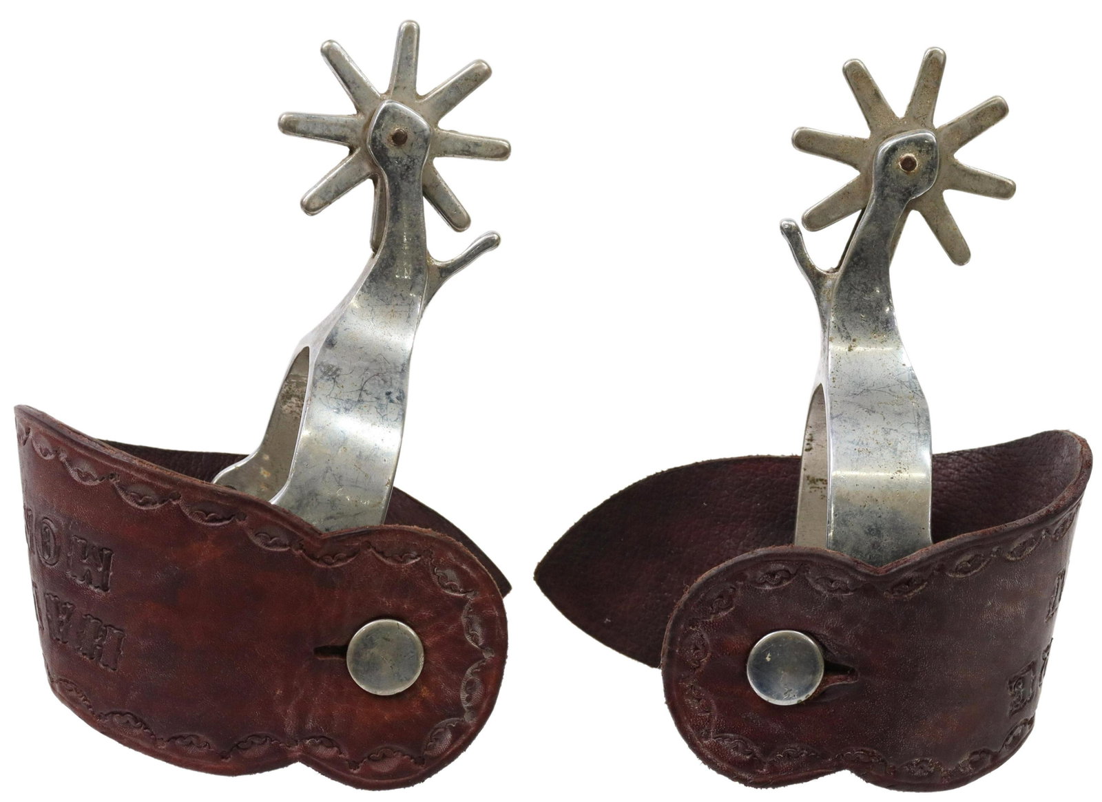 WESTERN HAVRE, MONTANA TOOLED LEATHER SPURS: (pair) Western cowboy spurs, silver-tone outside heel band, 2.5" rowels, eight points, on tooled leather heel strap marked Havre, Montana, metal oxidized, yoke: approx 3"w, 3.5"d, 1.75lbs total Start 