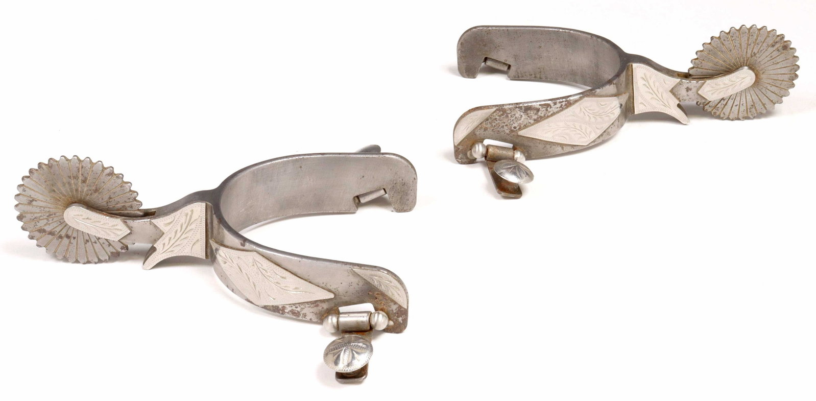 (PAIR) COWBOY SPURS SIGNED "101 WALLIS": (pair) Cowboy spurs, polished steel with foliate engraved nickel accents, each signed on the inside yoke "101 Wallis", yoke approx. 4.5"w, 3.25"d, 1.60lbs Start Price: $80.00