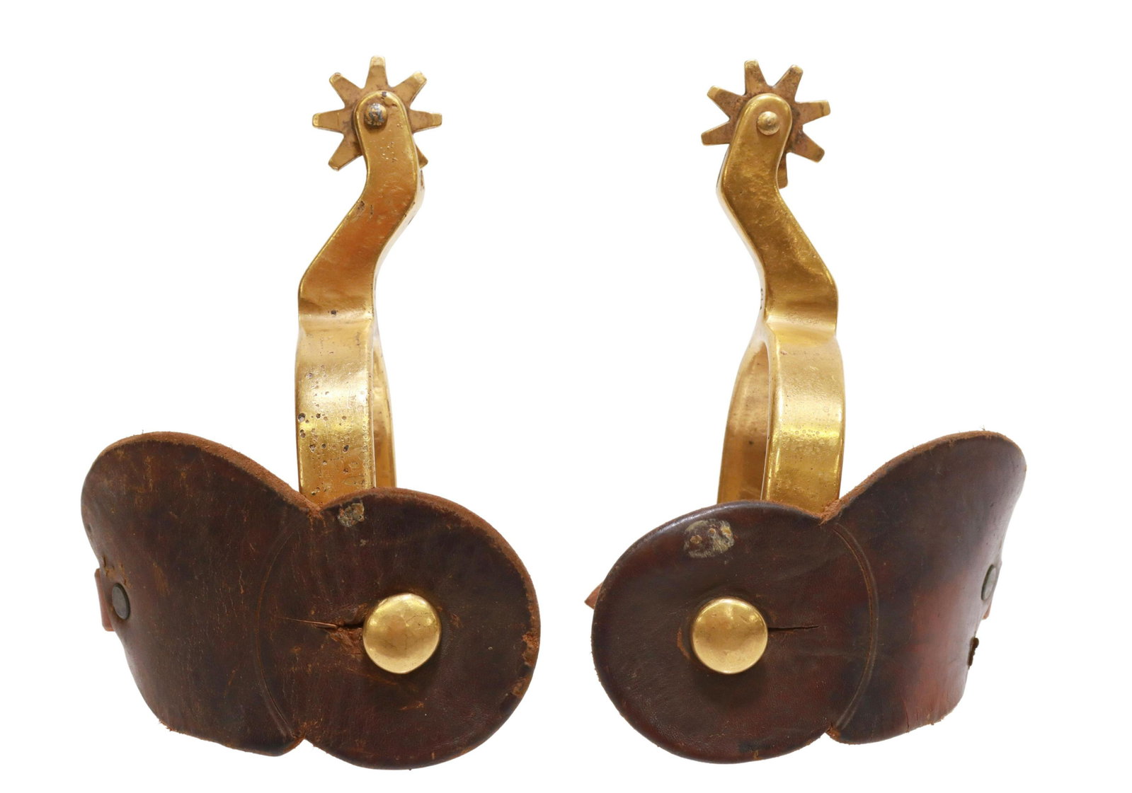 WESTERN GOLD-TONE METAL COWBOY SPURS: (pair) Western gold-tone metal spurs, plain heelband, 1.25" rowels, eight points, leather straps, neck with anchor or initial mark, yoke: approx 2.75"w, 3.25"d, 1.25lbs total Start Price: $60.00