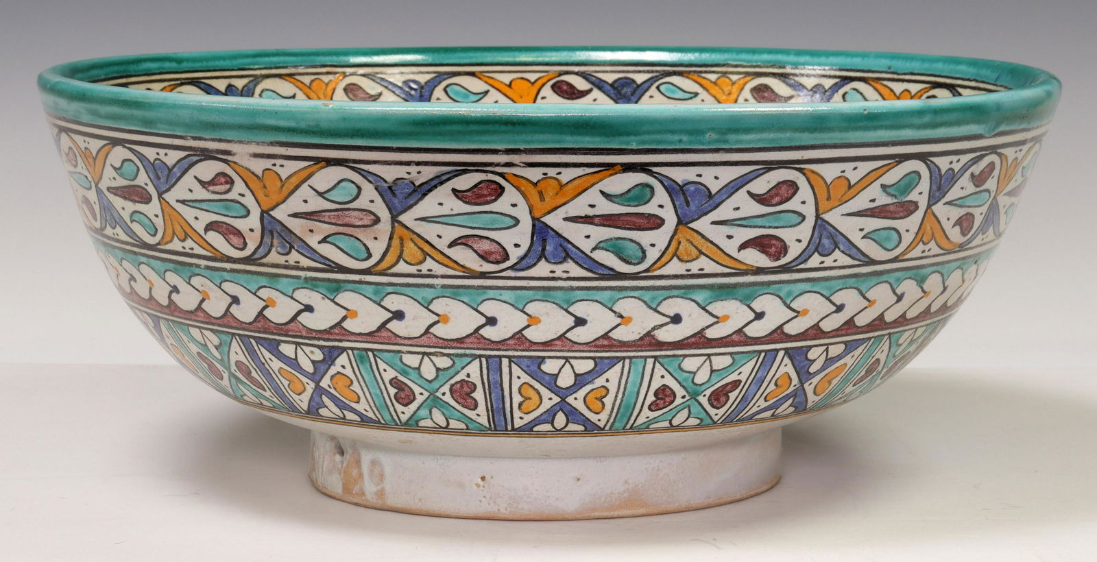 FES NAJI MOROCCAN POLYCHROME PAINTED POTTERY BOWL: Polychrome painted earthenware bowl, Art Naji Pottery, Fez, Morocco, in repeating foliate patterns, marked to bottom FES NAJI, with pierced holes to accommodate hanging hardware, approx 5.75"h, 13.75"