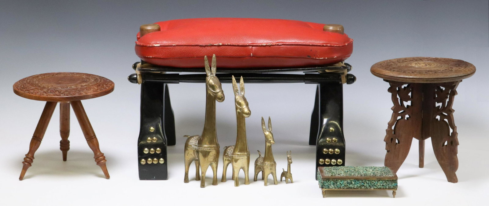 (7) DECORATIVE HOME WARES, CAMEL SADDLE STOOL: (lot of 7) Decorative seating and table items, including: (1) camel saddle stool, red leather seat, rising on black lacquered wood base with nailhead trim, approx 12.5"h, 20"w, 12.5"d; (2) diminutive 