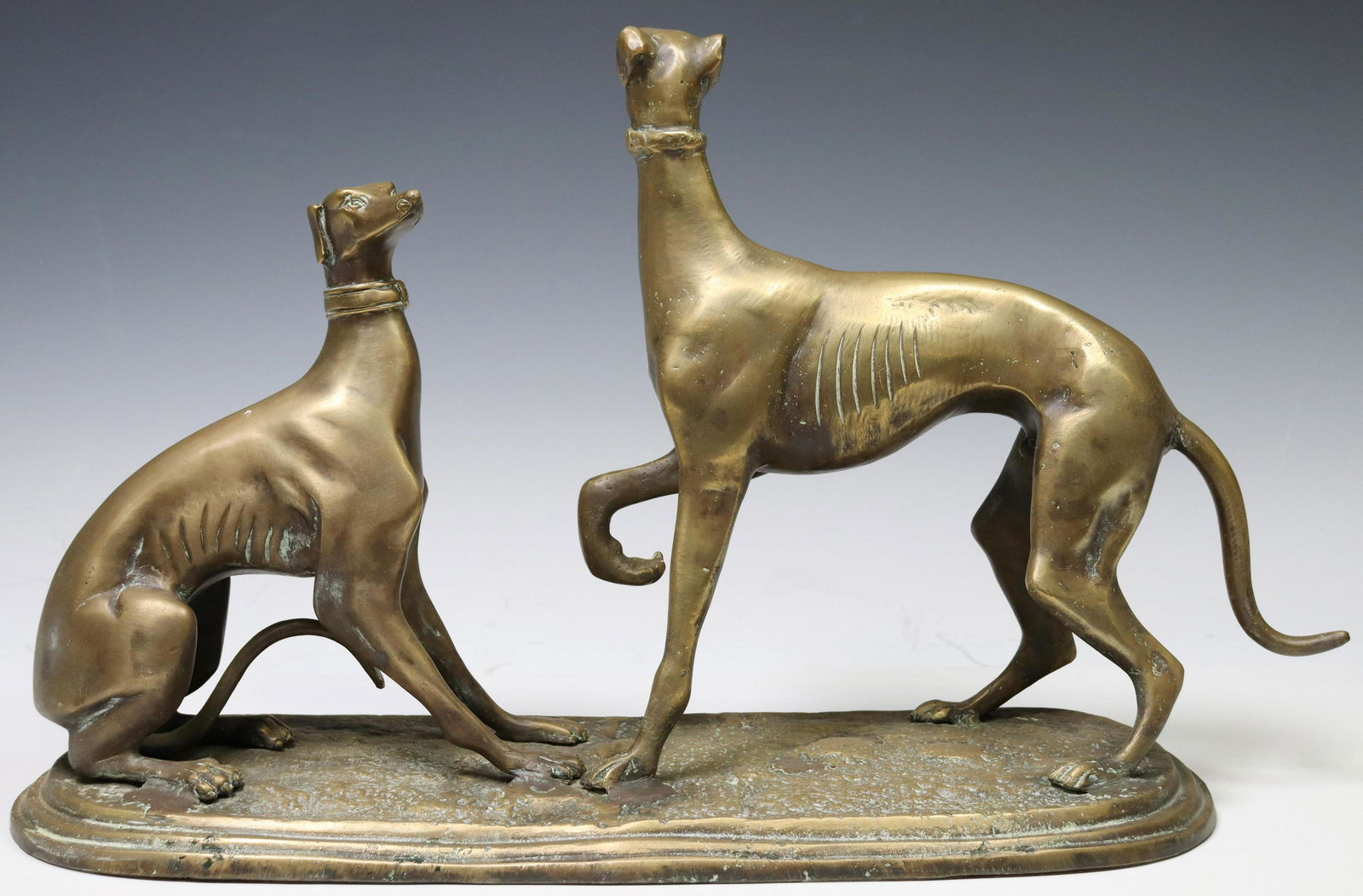 MAITLAND-SMITH BRONZE DOGS STATUE, 13.25"H: Maitland-Smith bronze statue, featuring two dogs in active poses, rising on naturalistically cast base, approx 13.25"h, 22.75"w, 7.75"d, 22.5lbs Start Price: $150.00