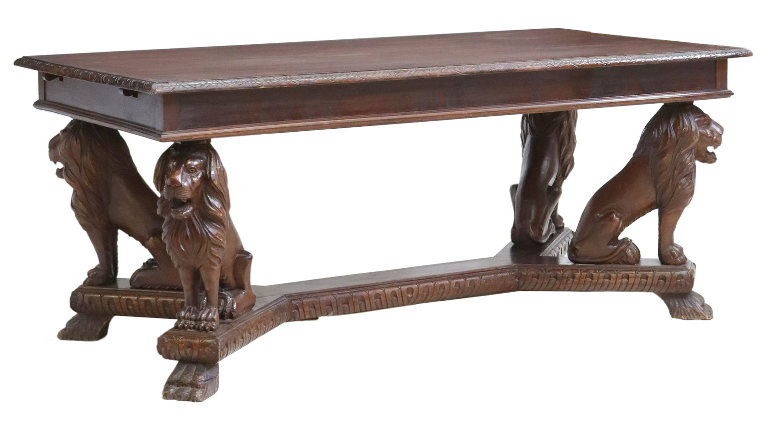 ITALIAN RENAISSANCE REVIVAL CARVED LION TABLE: Italian Renaissance Revival walnut table, early 20th c., rectangular top with molded edge, supported by carved lions seated above the cross stretcher, rising on paw feet, approx 30.75"h, 71"w, 37.25"d