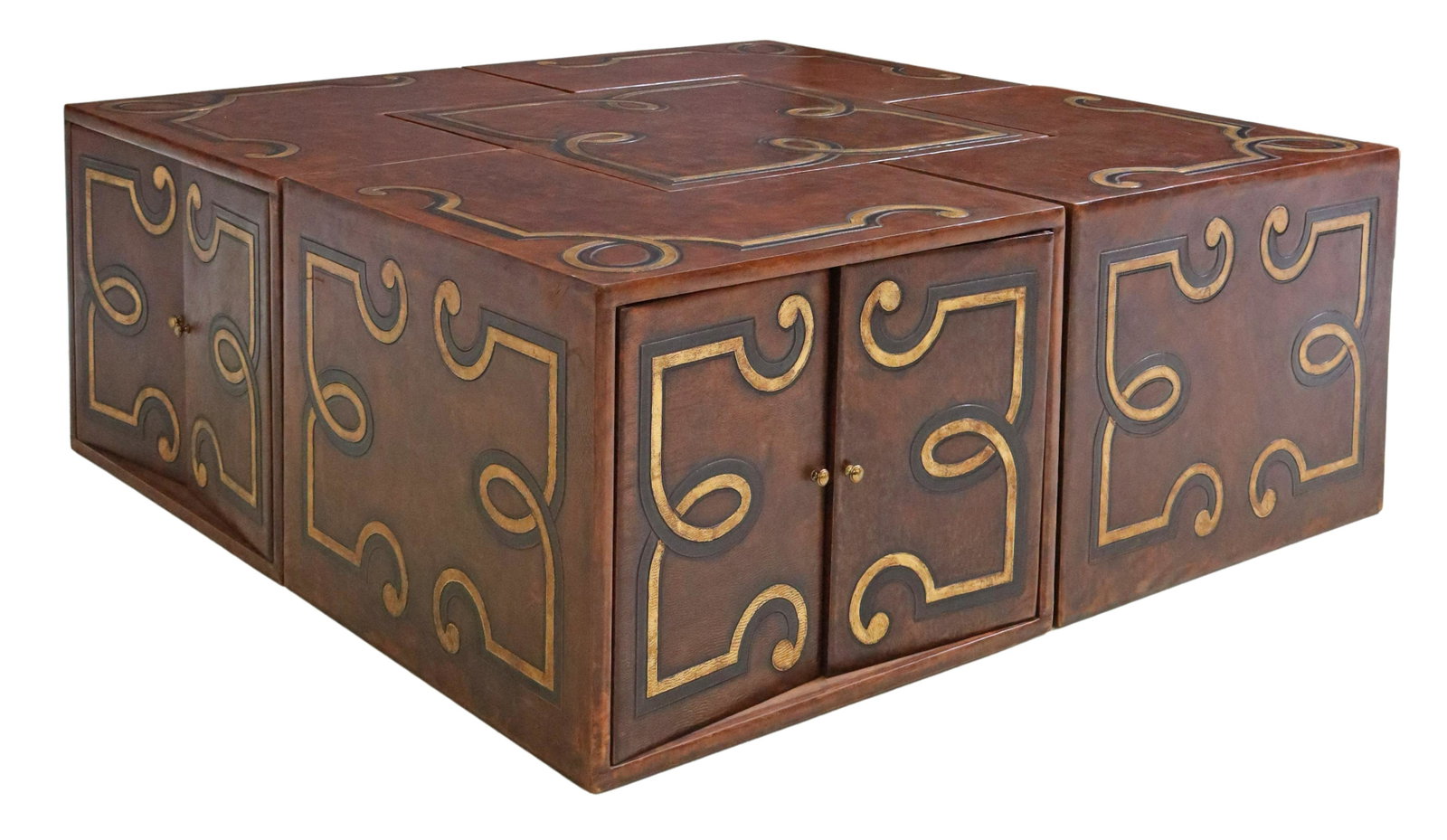 TOOLED LEATHER MODULAR BREAKAWAY COFFEE TABLE: Designer tooled leather-clad breakaway coffee table, late 20th c., in five sections, each corner unit with a double-door cabinet, center section: approx 20"h, 26"w, 26"d, overall: approx 20"h, 52"w, 5