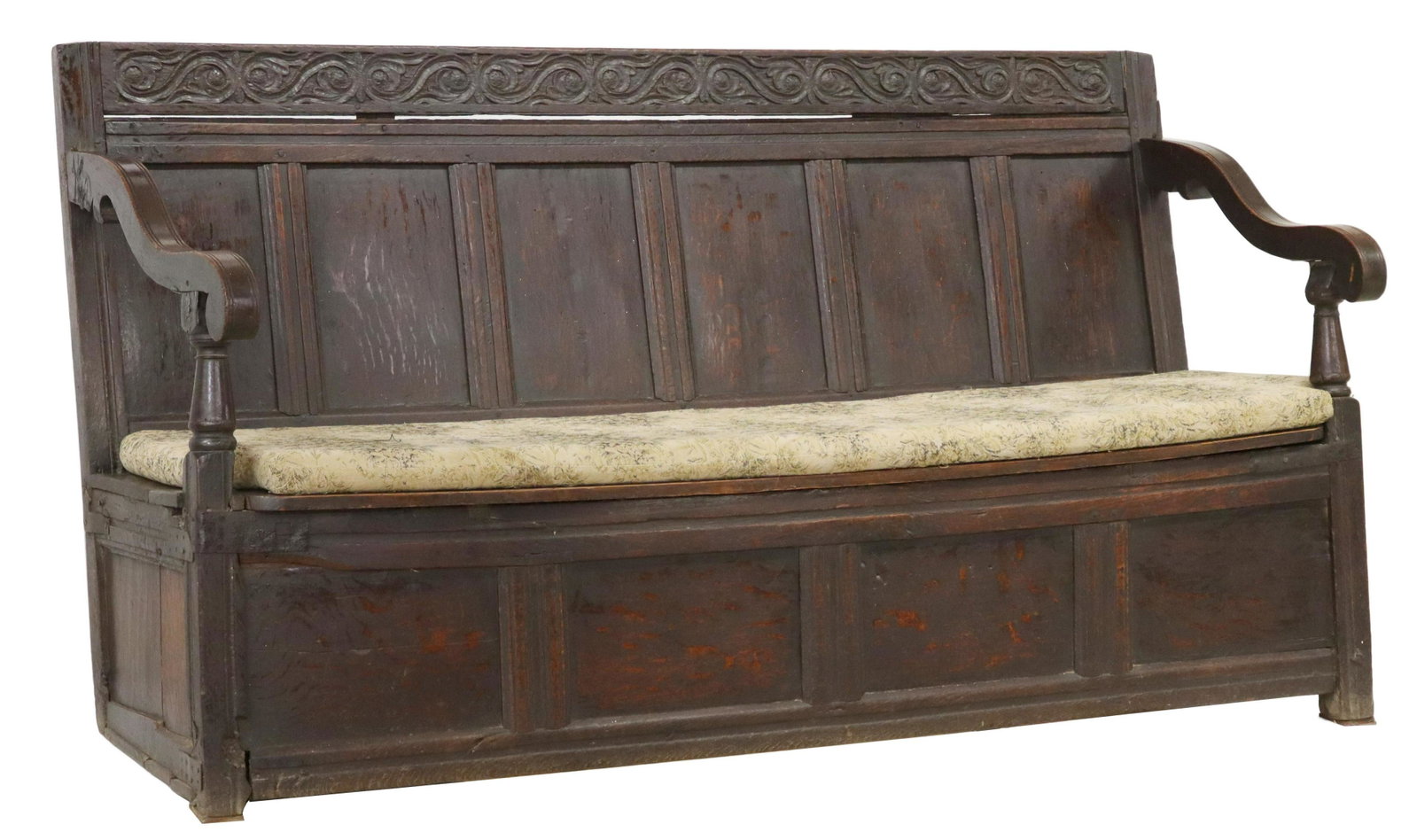 ENGLISH OAK HALL STORAGE SETTLE BENCH, 18TH C.: English oak settle hall bench, 18th c., having scrolling foliate carved crest, over paneled back, curved arms on turned supports, removable seat cushion above hinged seat, opening to interior storage,