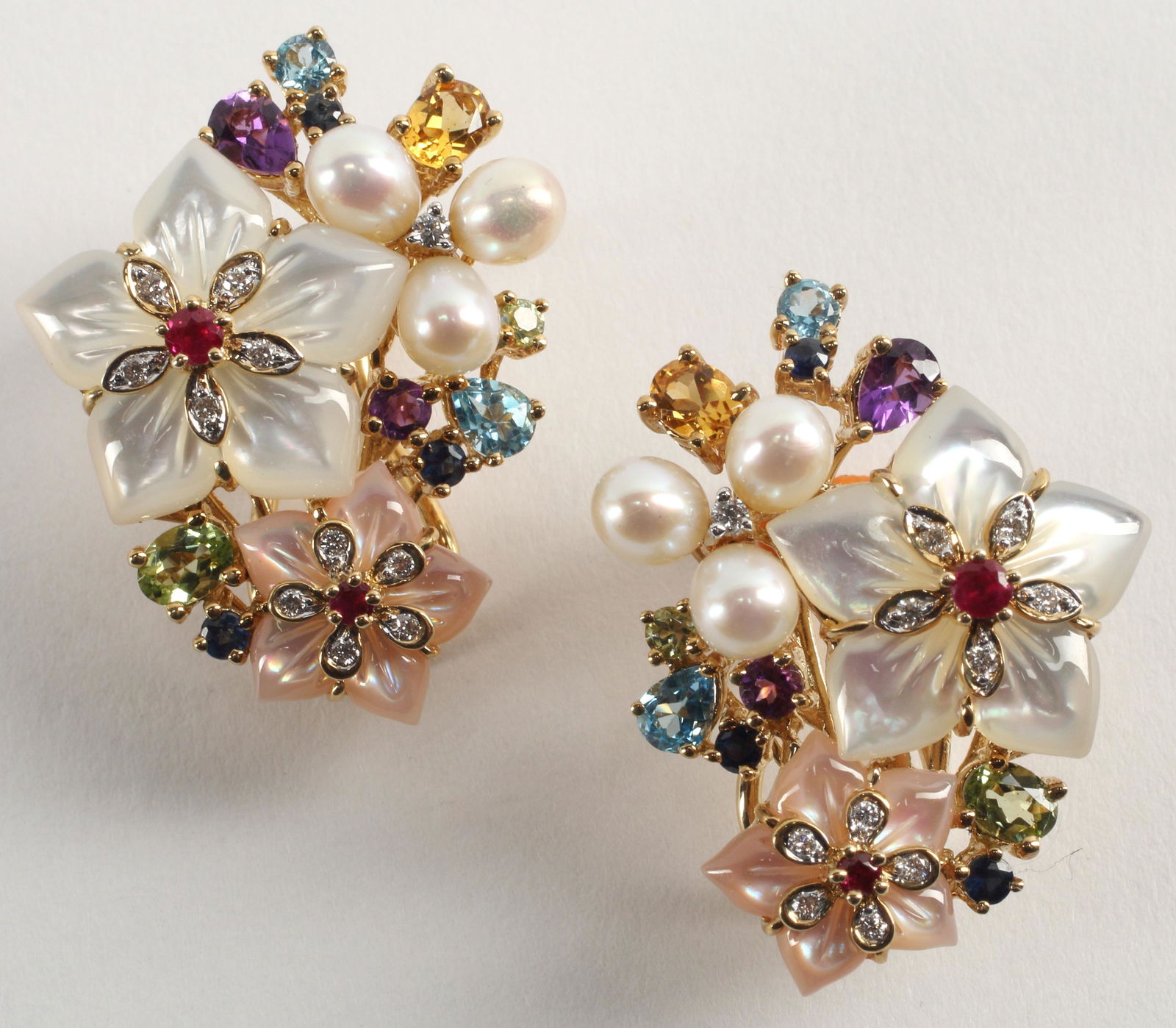 ESTATE 14KT GOLD MULTI-GEMSTONE FLOWER EARRINGS: (pair) Estate 14kt yellow gold (tested) pearl, pink and white mother-of-pearl, diamond, and multi-gemstone (blue topaz, peridot, amethyst, citrine, blue sapphire, and ruby) flower earrings, hallmarked