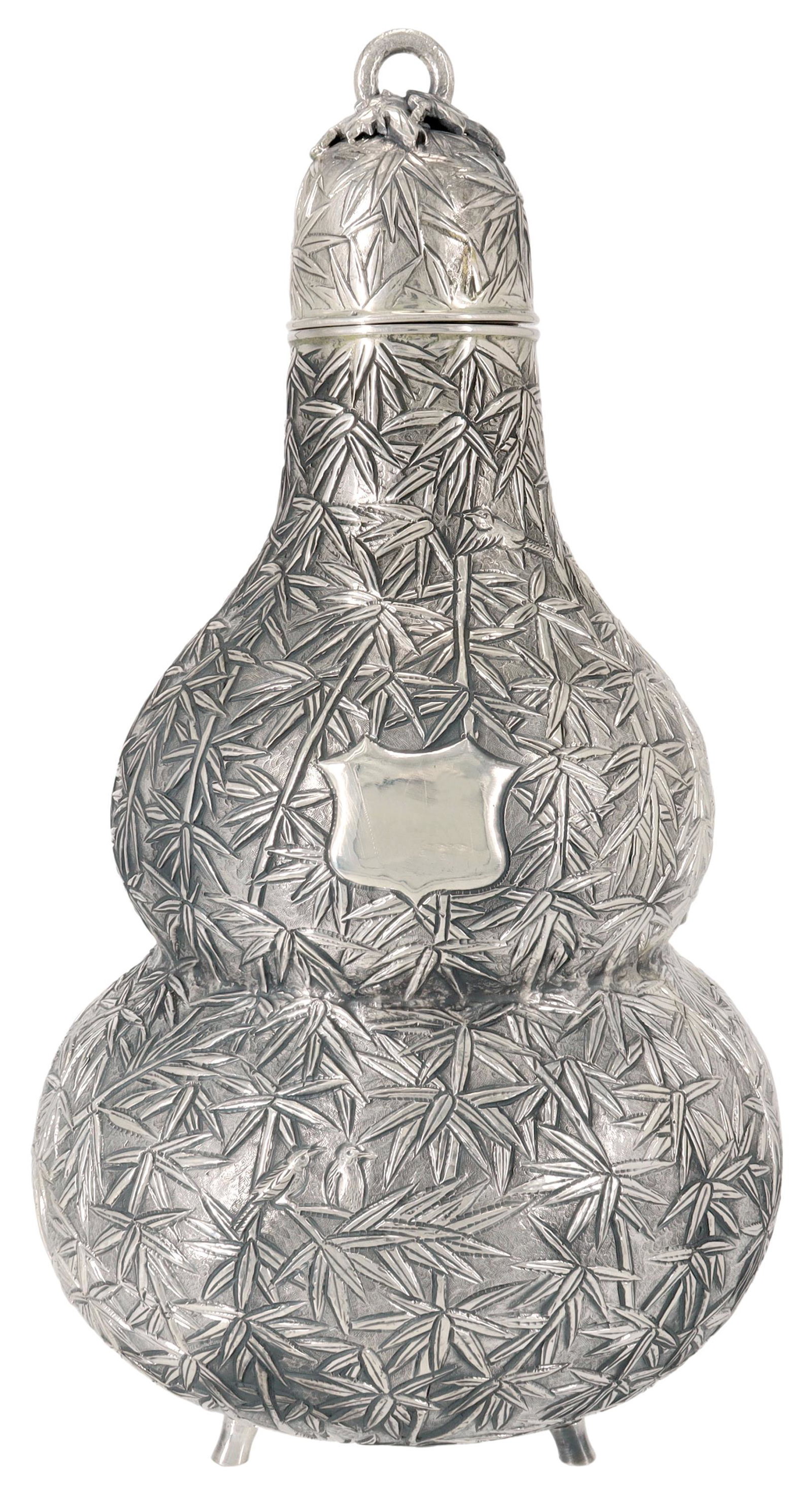 CHINESE EXPORT SILVER DOUBLE GOURD WINE VESSEL: Chinese Export silver double gourd-form wine vessel, Wang Hing & Company, Hong Kong, vacant shield-form cartouche, repousse birds perched on bamboo stalks, hallmarked WH 90, approx 11.5"h, 6.25"diam, 