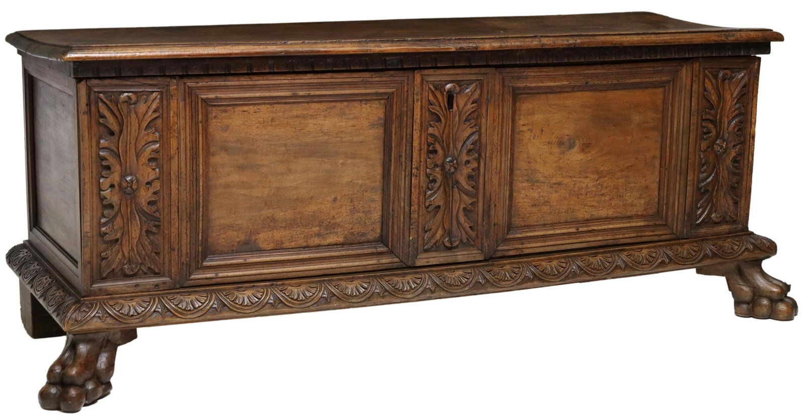 ITALIAN CARVED WALNUT CASSONE, 18TH C.: Italian carved walnut cassone/ chest, 18th c., hinged lid opening to storage interior, with side till, foliate and panel carved front, over lower lunette border, rising on paw feet, approx 25.25"h, 66