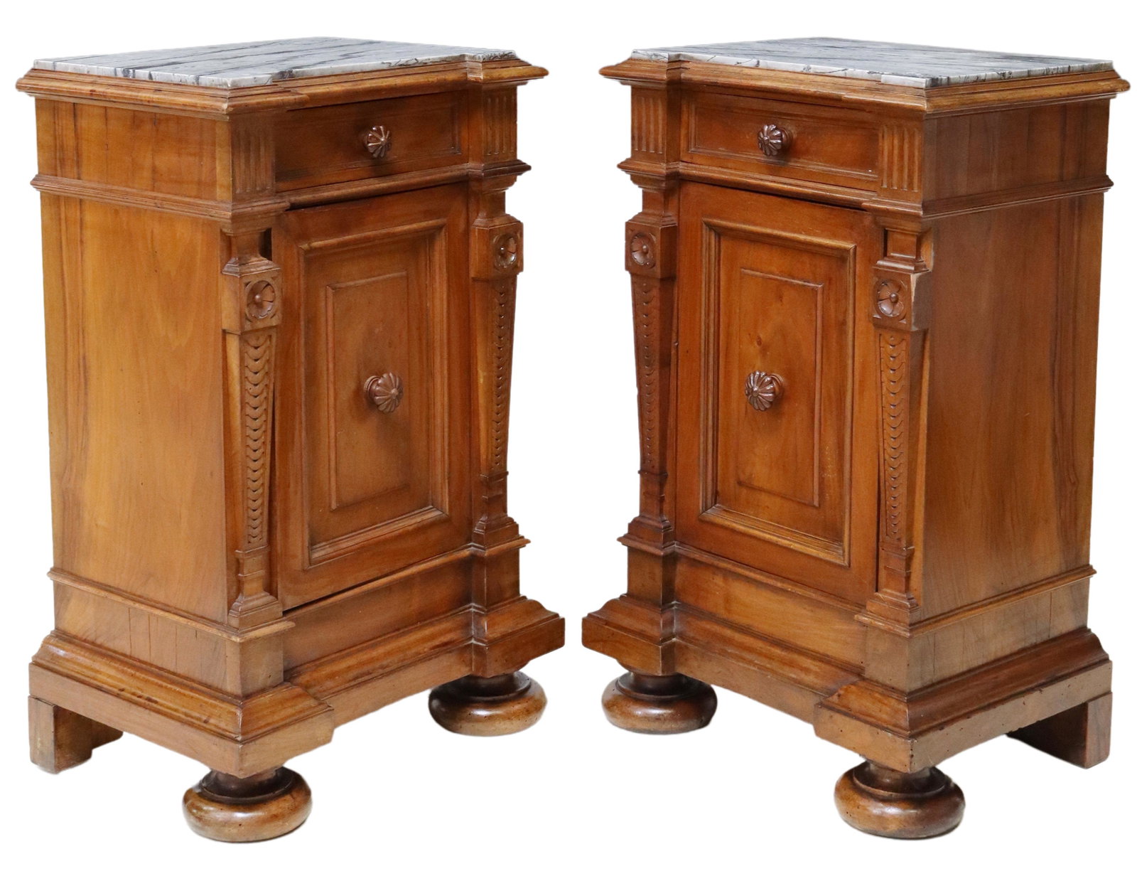 (2) ITALIAN CARVED WALNUT MARBLE-TOP NIGHTSTANDS: (pair) Italian carved walnut bedside cabinets, 19th c., having shaped inset marble top, single top drawer, over single cabinet, both with floriform pulls, flanked by tapered pilaster side supports, ri