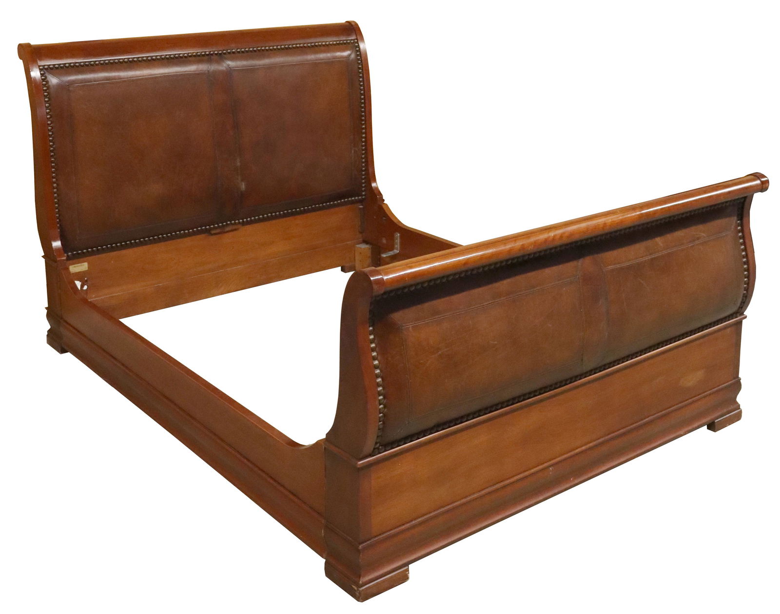 HENREDON LEATHER PANEL SLEIGH BED: Sleigh bed, Henredon, late 20th c., having rolled top rails, headboard and footboard with inset leather panels, accented with exposed stitching and large nailhead trim, rising on bracket feet, exterio