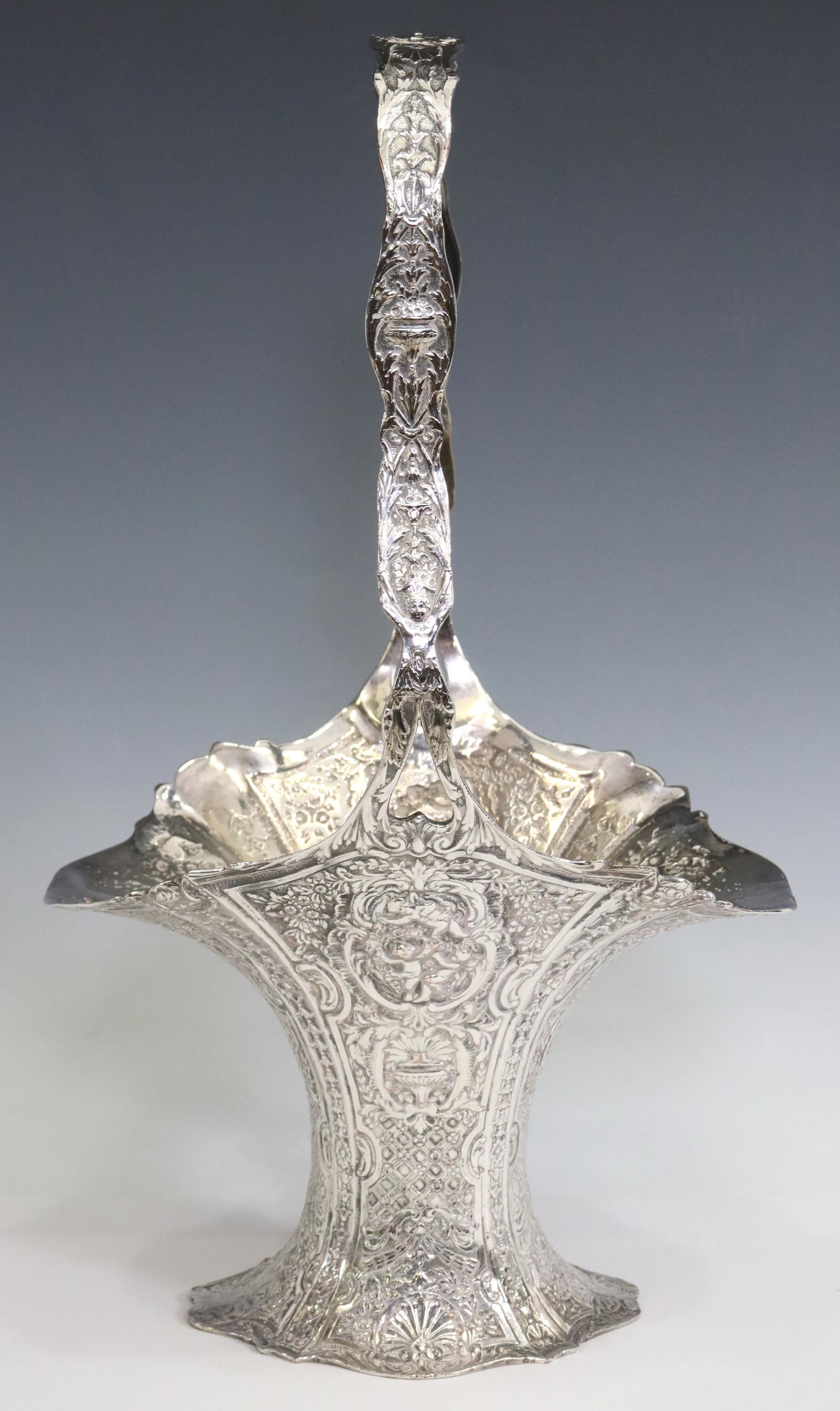 E.G. WEBSTER & SON SILVERPLATE BRIDE'S BASKET: American silverplate bride's basket, E.G. Webster & Son, in the Rococo taste, decorated with cherubs, flowers, rocaille and c-scrolls, approx 18.75"h, 10.75"w, 8.25"d, 2.75lbs (for shipping purposes o