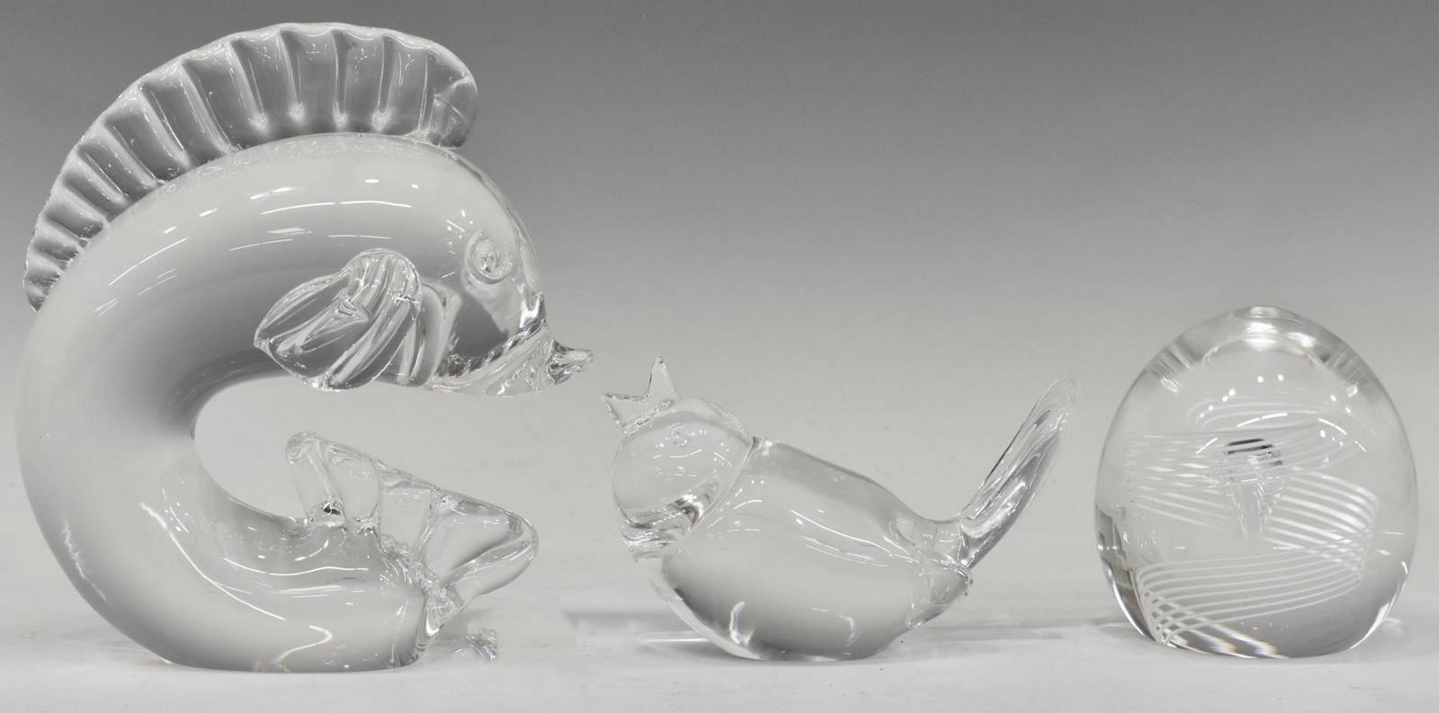 (3) STEUBEN ART GLASS FIGURES & PAPERWEIGHT: (lot of 3) Steuben colorless art glass paperweights and figures, designed by George L. Thompson (American, 1913-1981), including: (1) leaping dolphin, shape #7880, approx 5.75"h, 5.25"w, 3"d, (1) song