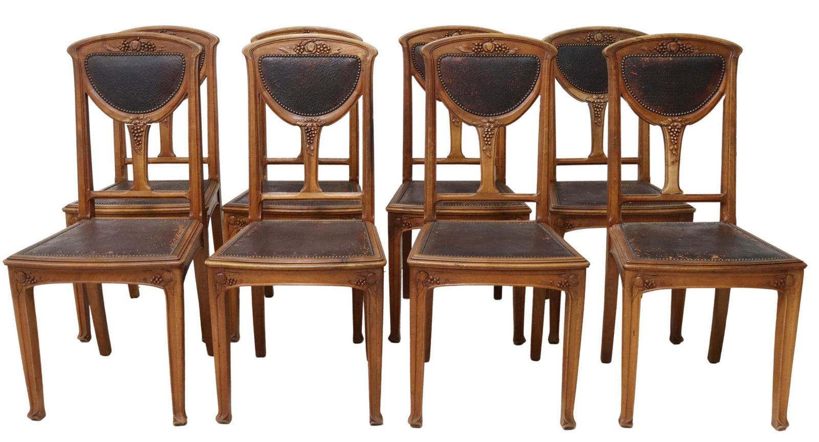 (8) FRENCH ART NOUVEAU CARVED DINING CHAIRS: (lot of 8) French Art Nouveau carved side chairs, early 20th c., having pierced back with carved fruit motifs, in worn brown upholstery, with nailhead trim, rising on squared supports, approx 38.5"h,