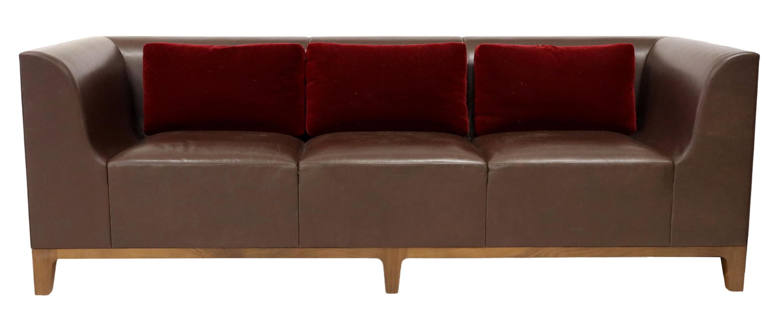 MODERN BROWN STITCHED LEATHER THREE-SEAT SOFA: Modern brown stitched leather sofa, three seat, rising on tapered wood legs, accompanied by (3) red mohair pillows, unmarked, some surface wear to leather, approx 33.25"h, 96"w, 35"d, seat height: 19"