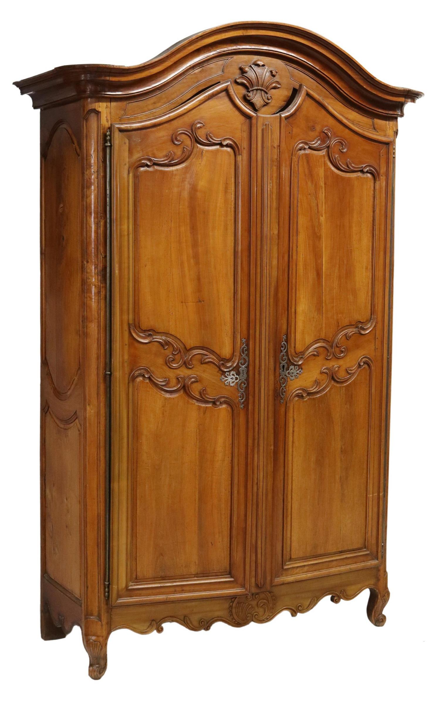 FRENCH PROVINCIAL FRUITWOOD ARMOIRE, 102.5"H: French Provincial Louis XV style fruitwood armoire, 18th/ 19th c., having molded cornice, over fleur-de-lis crest, dual paneled doors, with unusual triple lock, scalloped apron, rising on cabriole leg