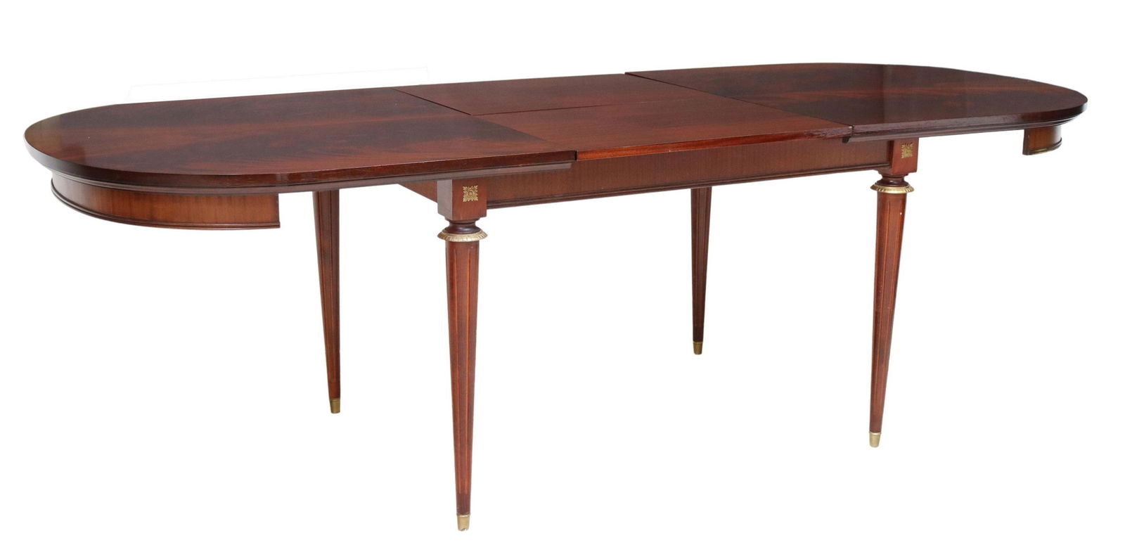 FRENCH LOUIS XVI STYLE MAHOGANY DRAW-LEAF TABLE: French Louis XVI style mahogany draw-leaf table, 20th c., having ovular top, accompanied by two interior draw leaves, rising on fluted and tapered legs with gilt metal accents, approx 30"h, 71.25"l, 3