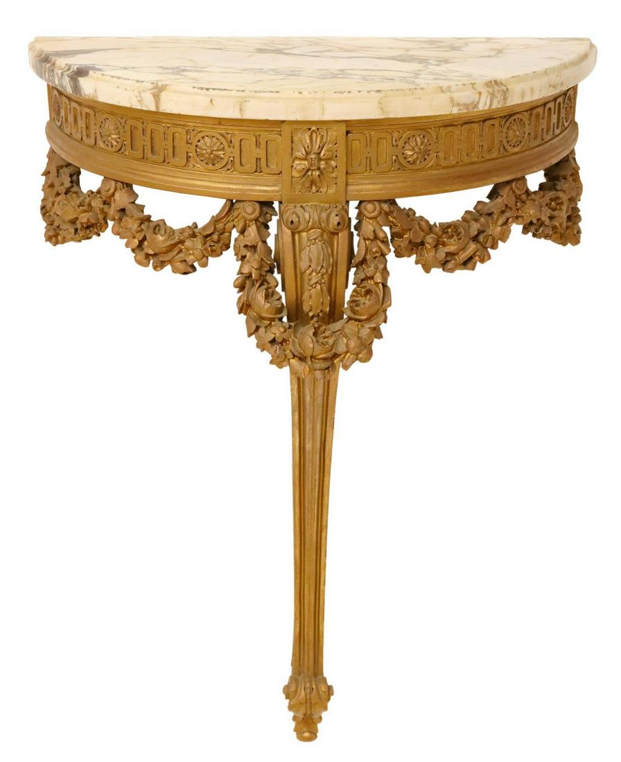 LOUIS XVI STYLE GILTWOOD WALL BRACKET/ CONSOLE: French Louis XVI style giltwood wall-mounted console table, late 19th c., demilune form with marble top, running ornamentation border, over floral swags, rising on cabriole leg, ending in foliated who