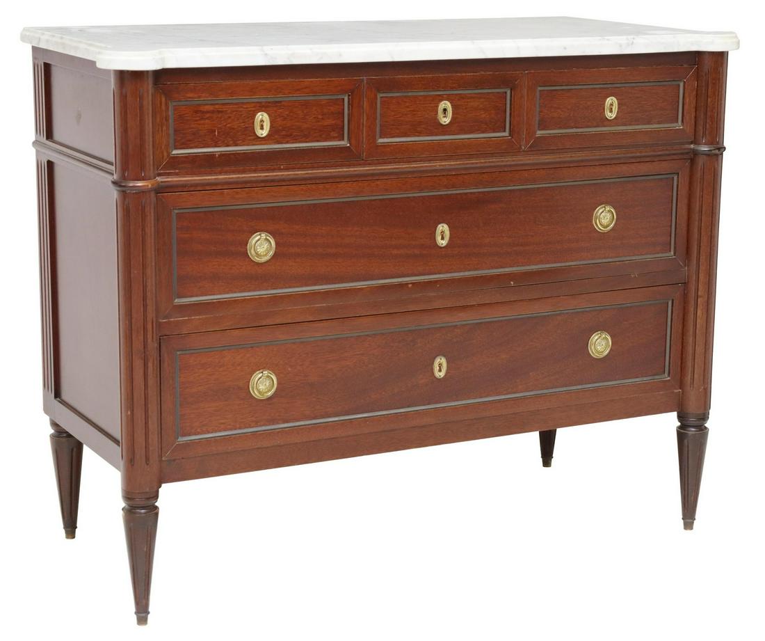 FRENCH LOUIS XVI STYLE MARBLE-TOP MAHOGANY COMMODE: French Louis XVI style marble-top mahogany commode, 20th c., three drawers, framed by fluted corner posts, rising on tapered legs, approx 34"h, 44"w, 19.75"d Start Price: $350.00