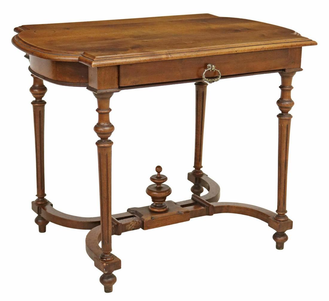 FRENCH LOUIS XVI STYLE WALNUT WRITING TABLE: French Louis XVI style walnut writing table, late 19th c., having shaped top, over single drawer, rising on fluted legs, joined with X-form cross stretcher, centering finial, rising on turned feet, re