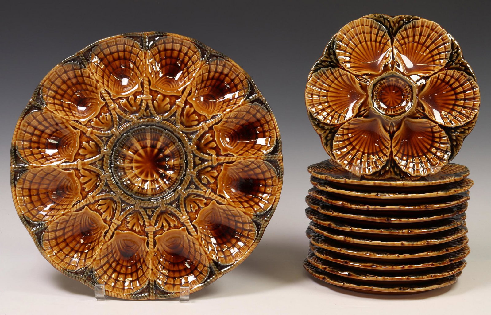(12) FRENCH SARREGUEMINES FAIENCE OYSTER SERVICE: (lot of 12) French faience oyster service, Sarreguemines, 20th c., including: (11) plates, approx 9" diam; (1) serving platter, approx 14.5" diam; 19.75lbs total Start Price: $100.00
