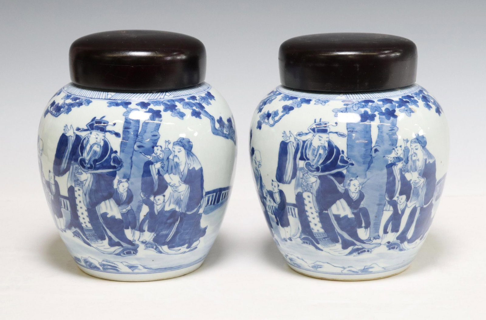 (2) CHINESE BLUE AND WHITE PORCELAIN MELON JARS: (lot of 2) Chinese blue and white porcelain melon jars, with later wood covers, each depicting figural scene of elders and children in a garden, bats at back, approx 8"h, 7" diam, 6.25lbs total Start 