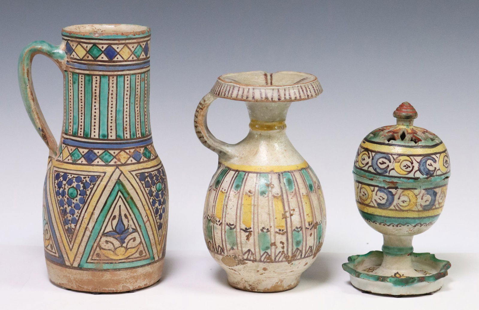 (3) MOROCCAN GLAZED POTTERY VESSELS: (lot of 3) Earthenware pottery vessels, likely from Morocco, in green, yellow, and blue glazes, including: (1) censer/ incense burner, (1) oil jug, (1) tankard/ pitcher, largest: approx 9.25"h, 4.25"d