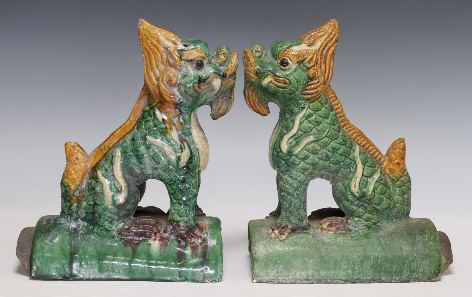 (2) CHINESE SANCAI GLAZED QILIN FIGURAL ROOF TILES: (lot of 2) Chinese Sancai glazed figural roof tiles, in the form of qilin, on arched base, approx 11"h, 8.5"w, 4.5"d, 6.2lbs total Start Price: $125.00